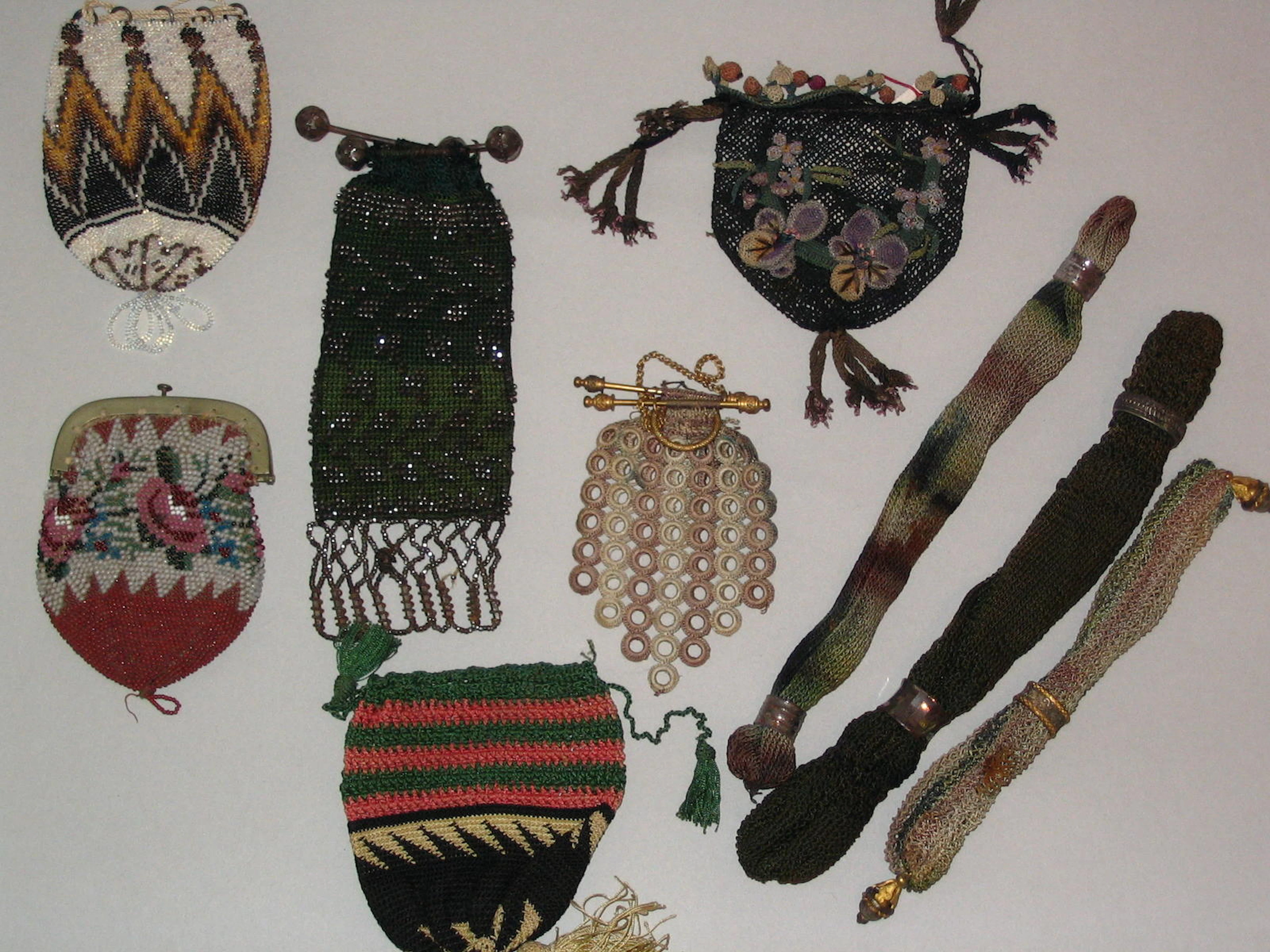 A group of five 19th century fans and coin purses