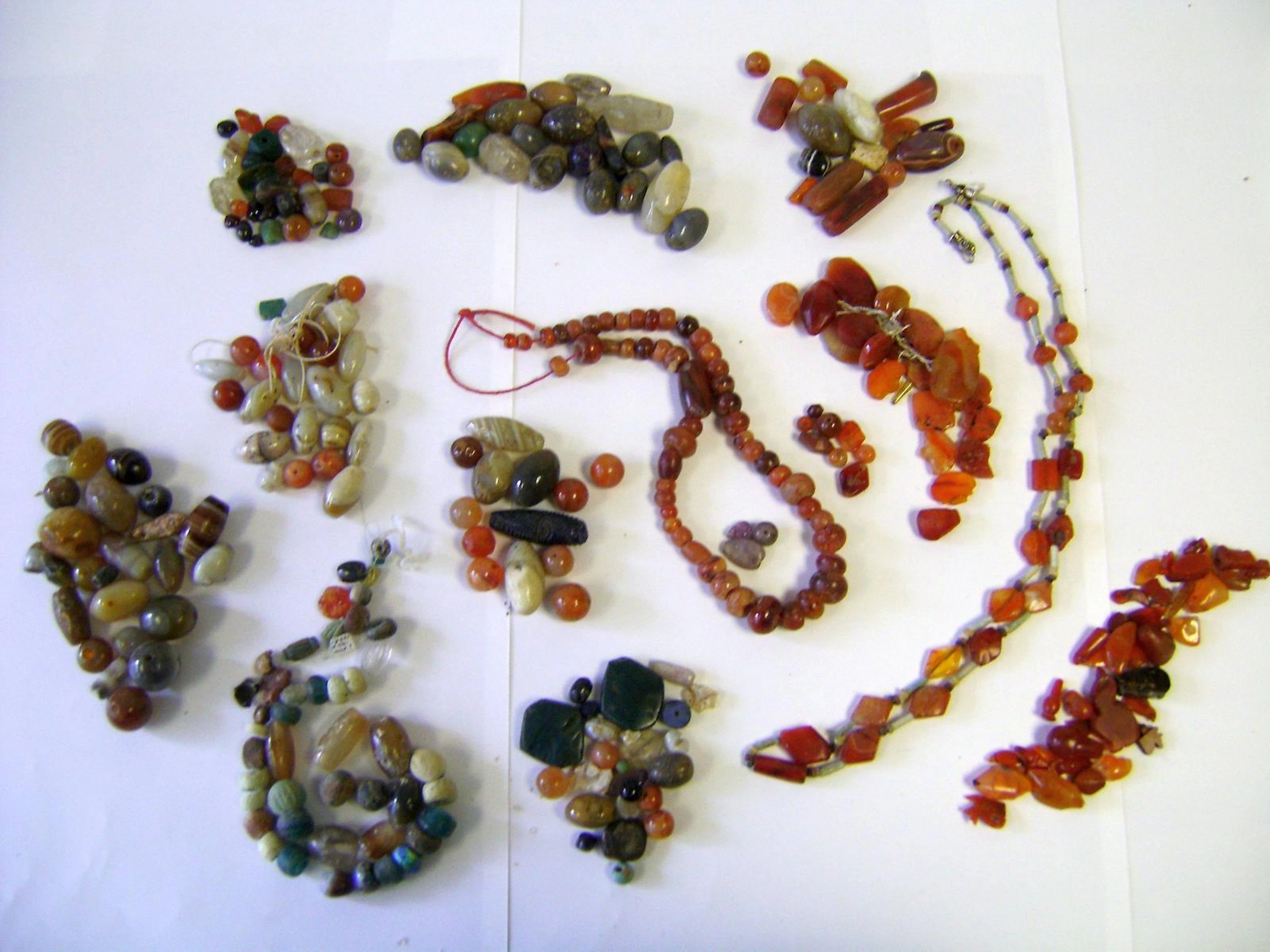 A large group of mostly hardstone beads, and some glass and glazed composition beads and amulets a lot