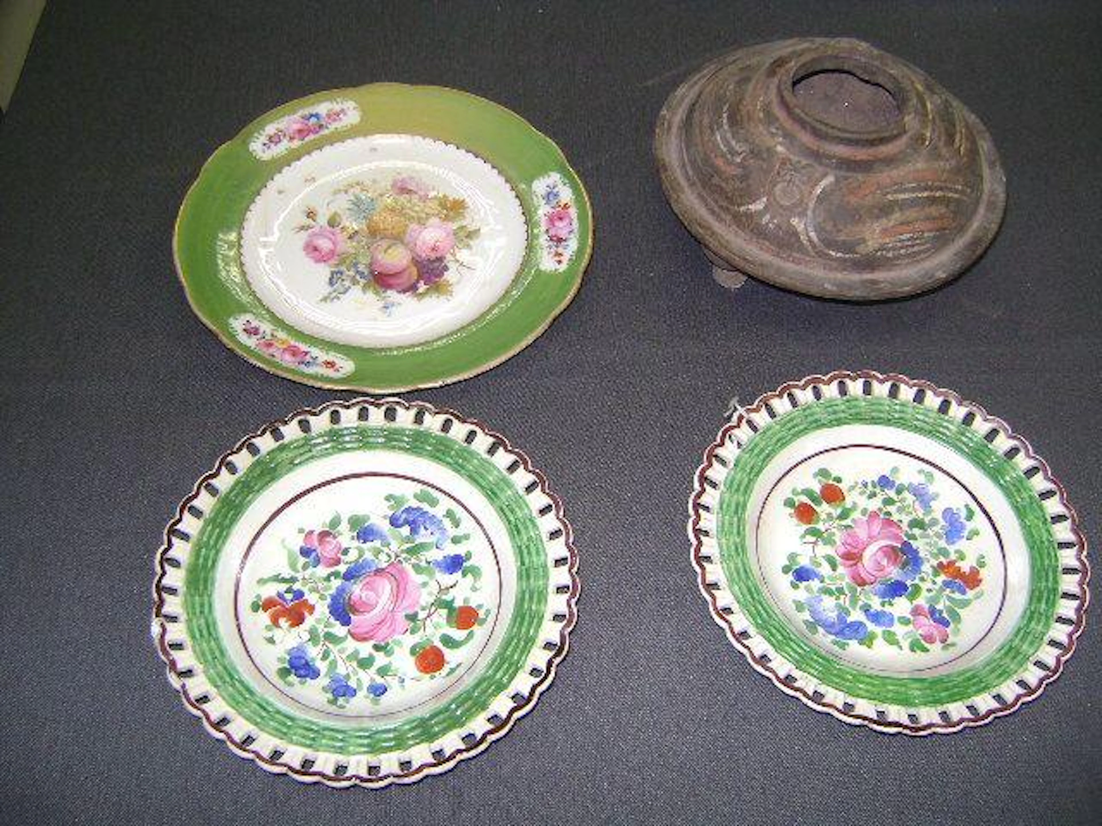 A Nantgarw plate, a pair of Welsh pottery plates and an early Chinese unglazed pot.(4)