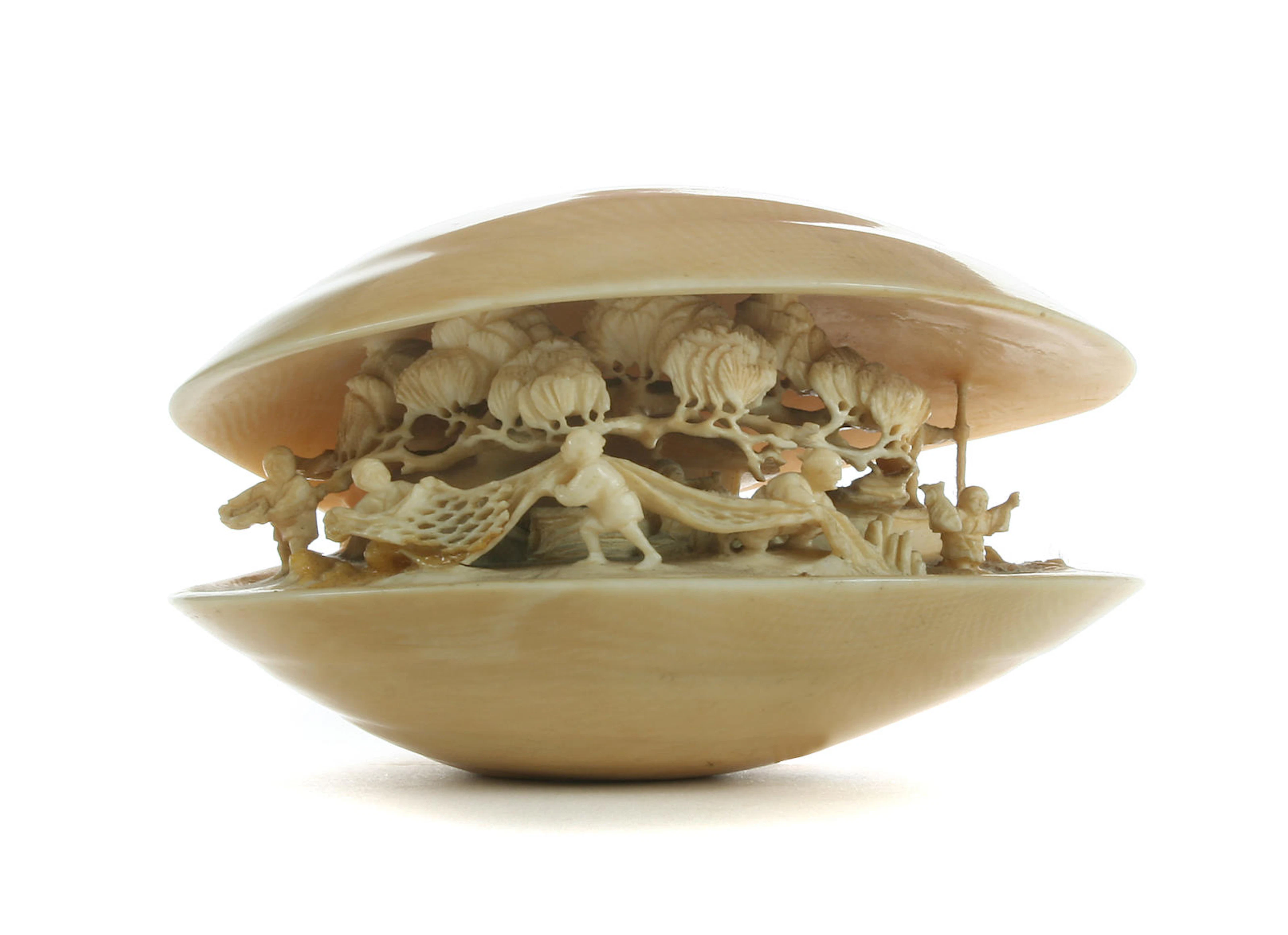 A stained Japanese ivory anabori netsuke of a clam's dream by Yumegyoku Meiji period