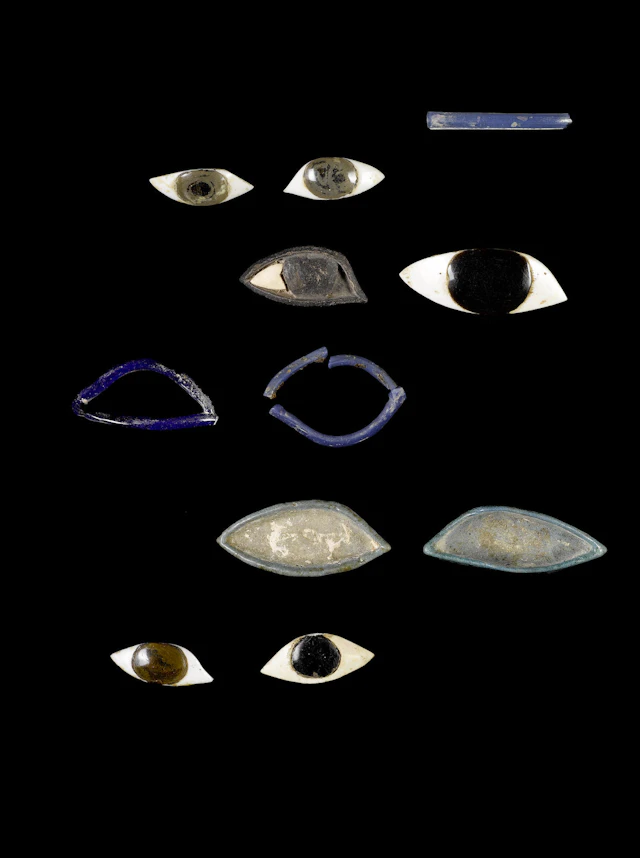 A pair of Egyptian eye inlays and eleven mixed eye fragments 13