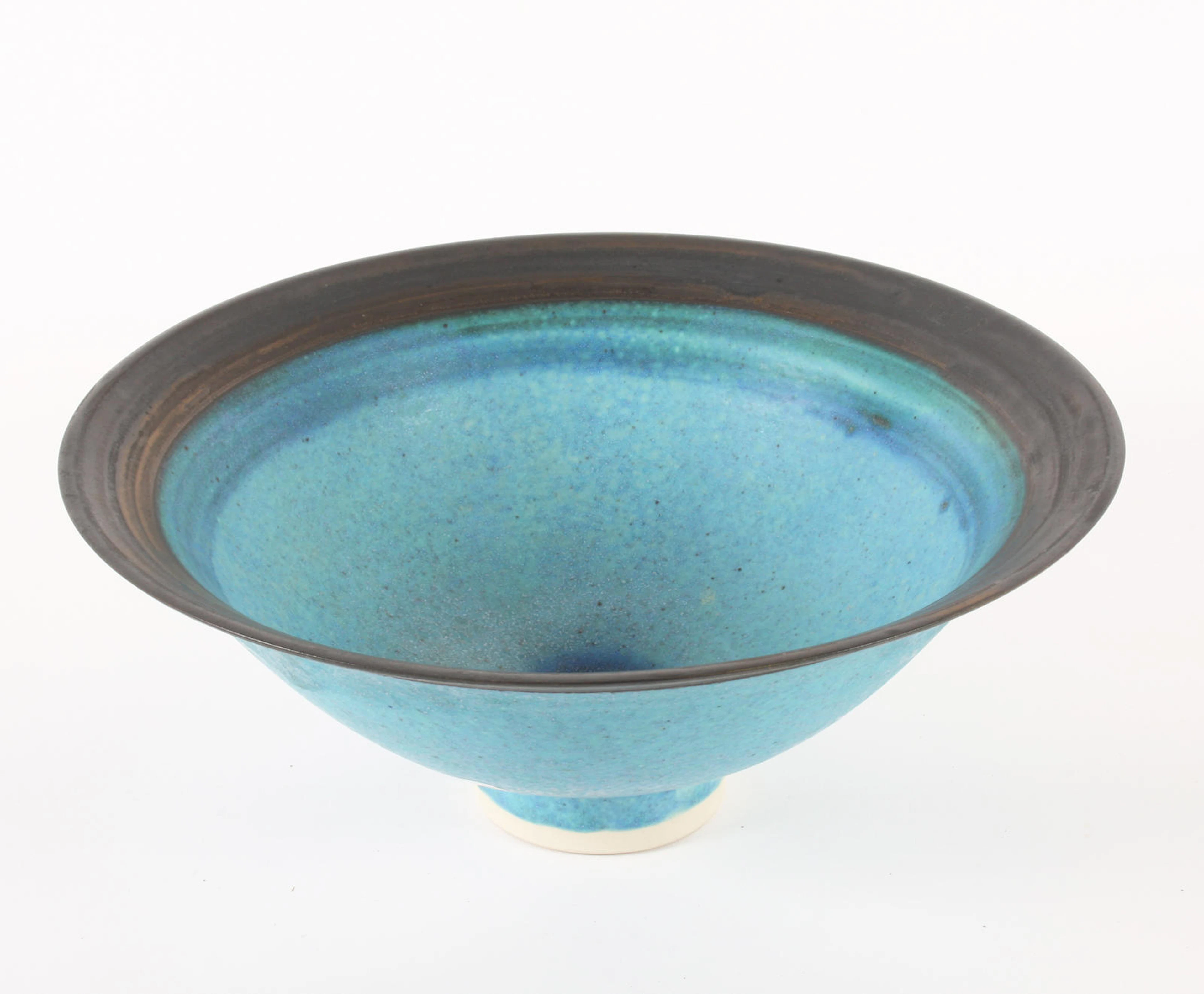A blue-glazed footed bowl by Emmanuel Cooper (Born 1938)