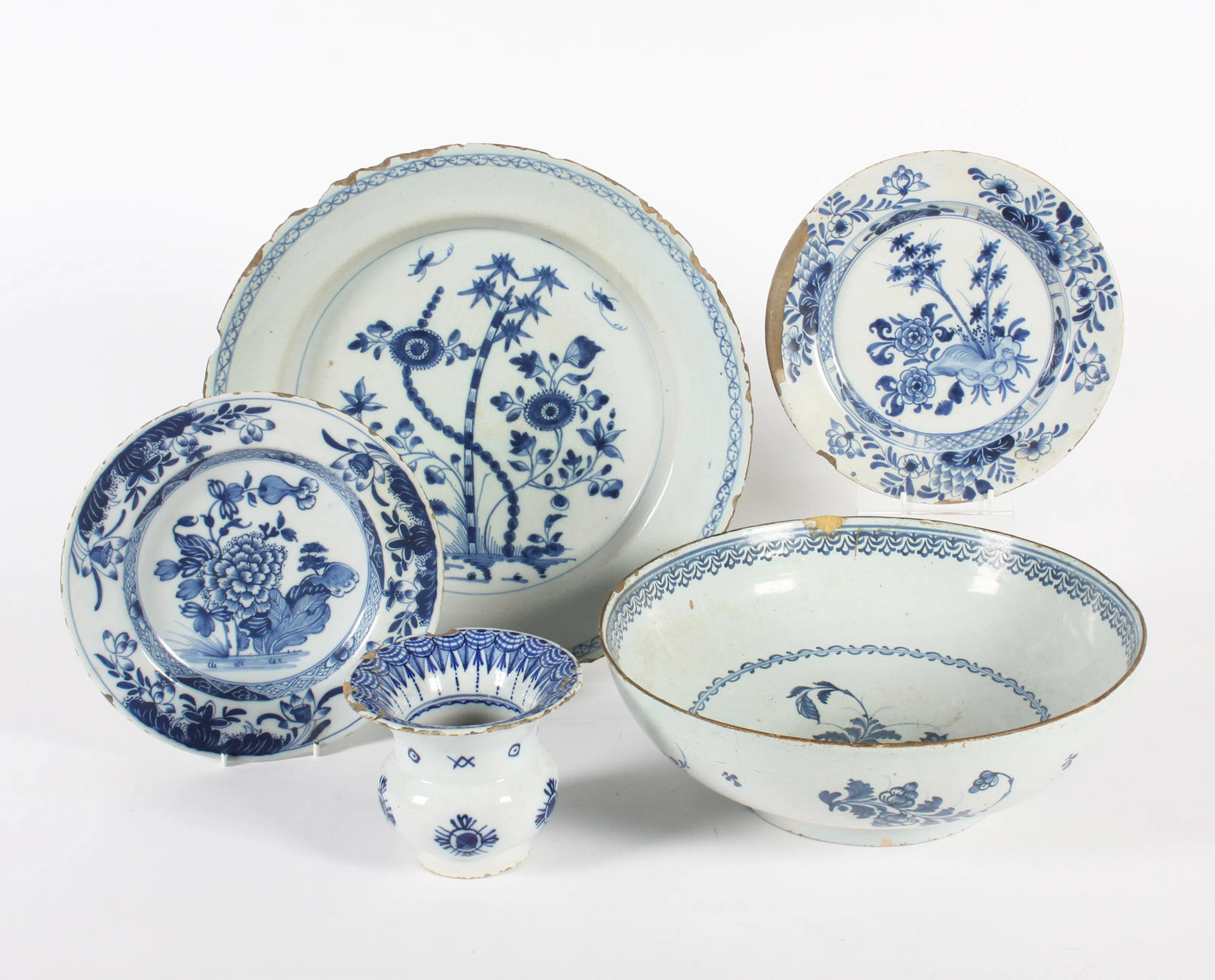 A delftware bowl, a large dish, two plates and a small spitoon 18th century