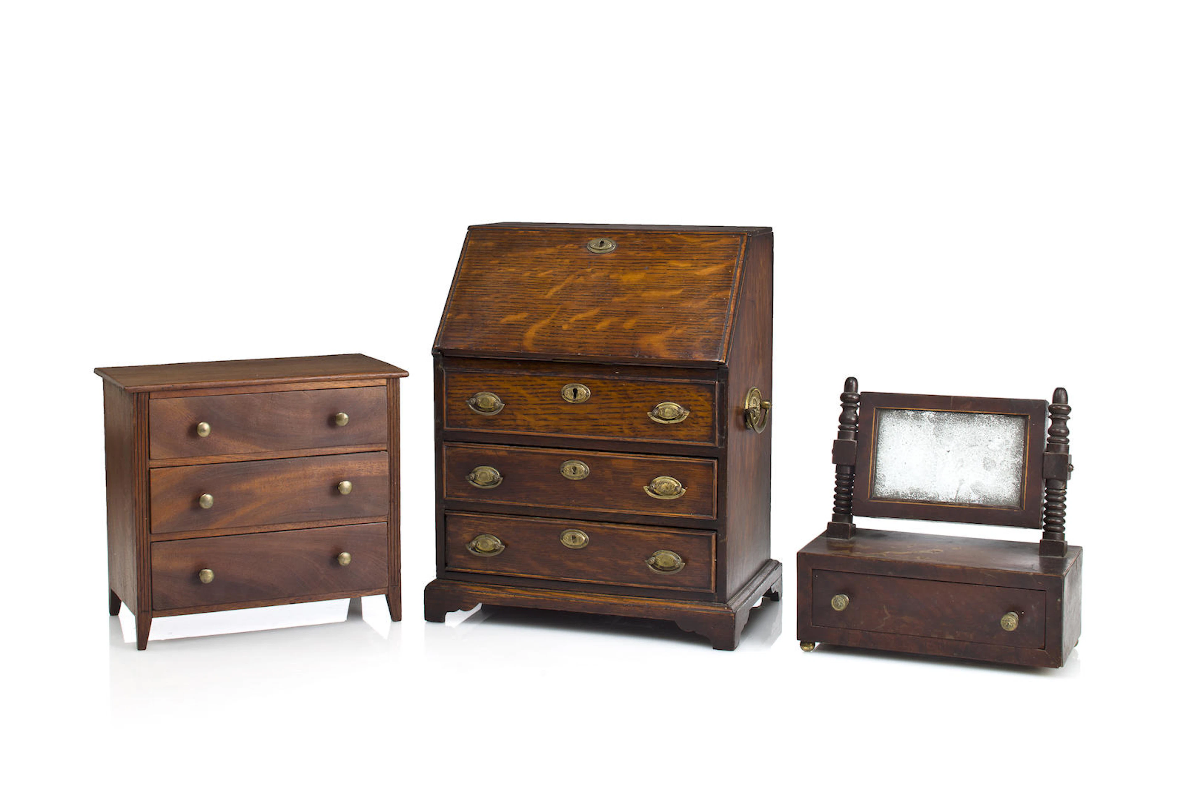 Three miniature furniture articles, including a chest of drawers, a desk and a dressing mirrorlate 19th century and later