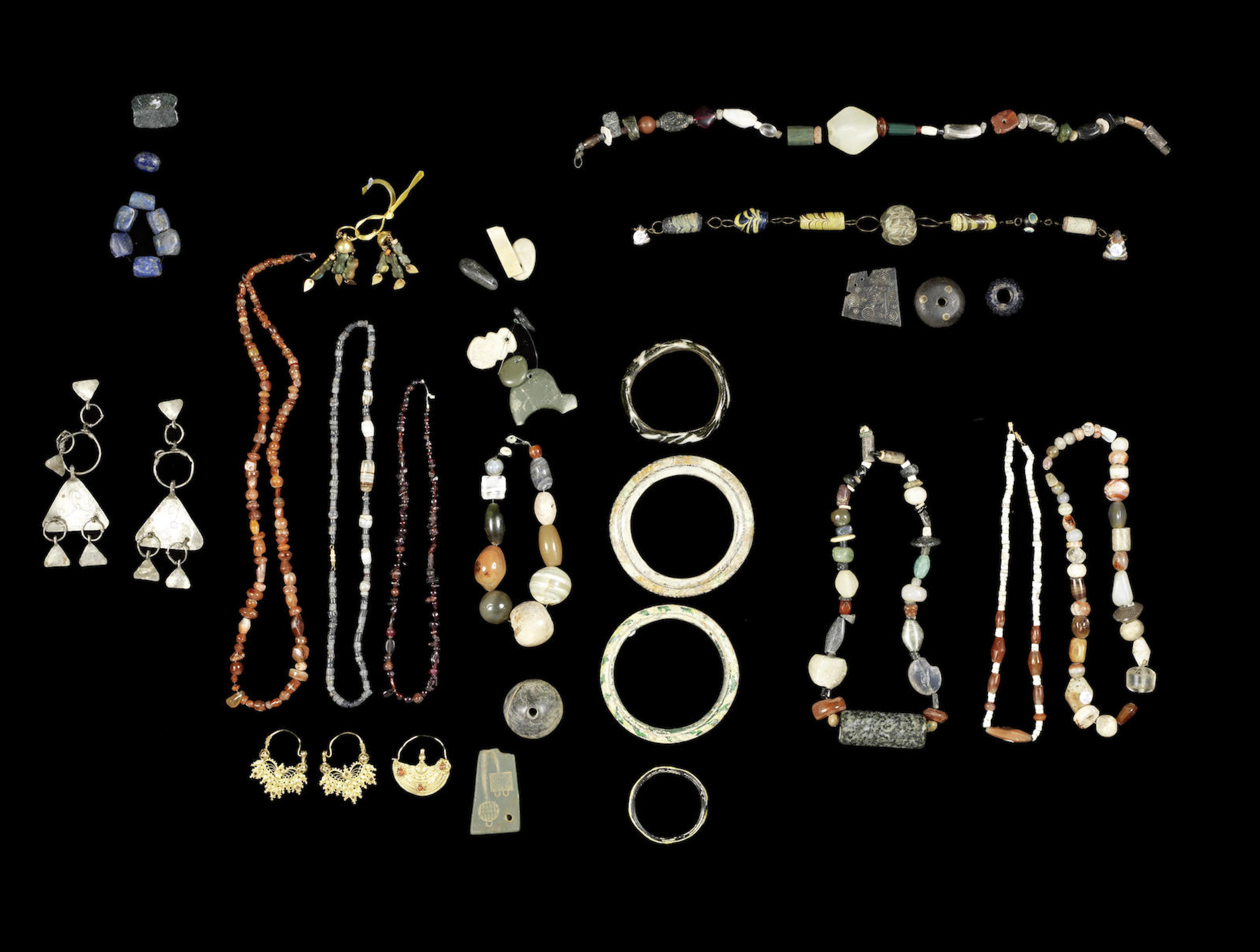 A group of Western Asiatic, Roman and later beads and a group of glass beads and other items, a lot