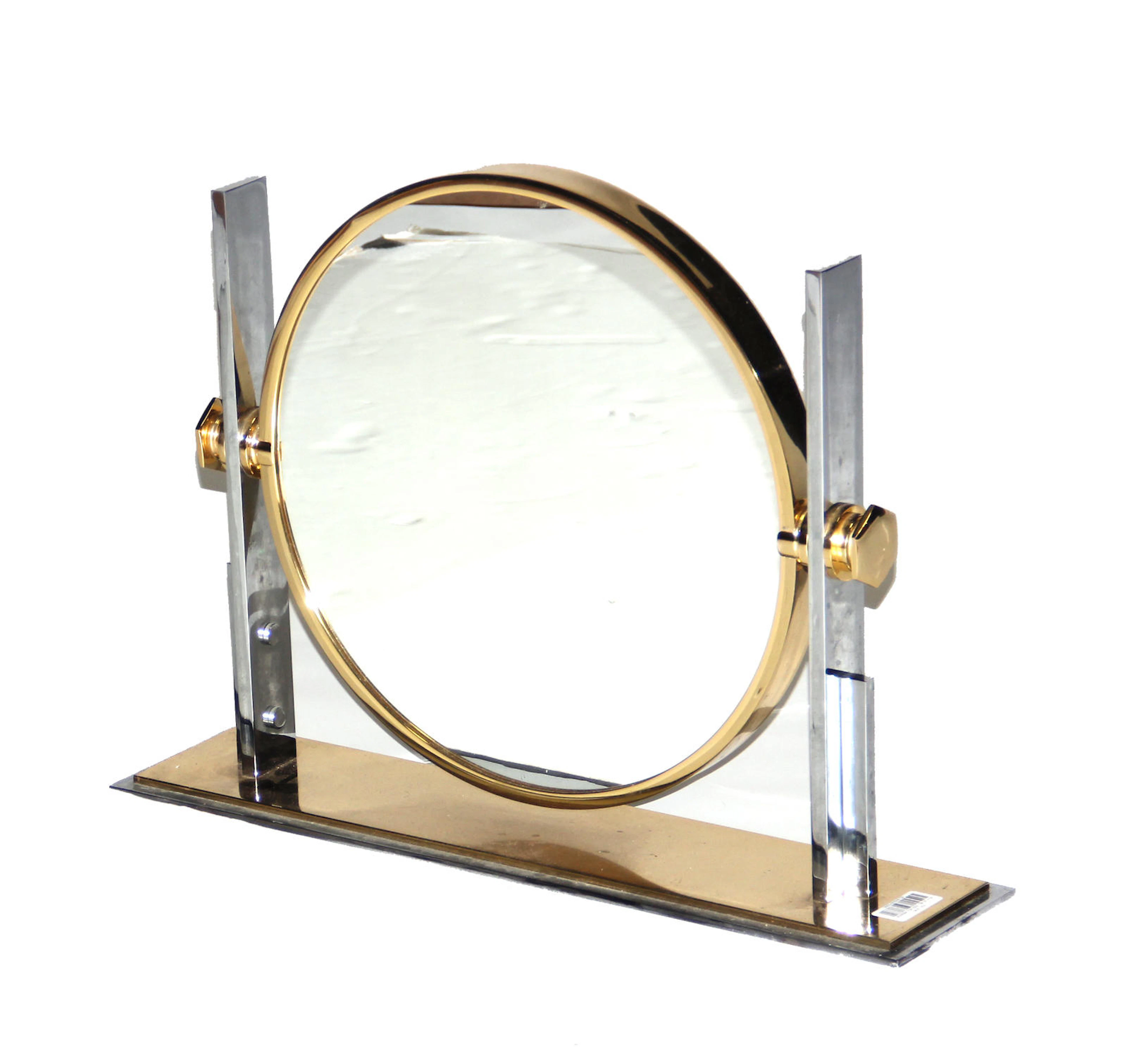 A deco style chromed metal and brass table mirror