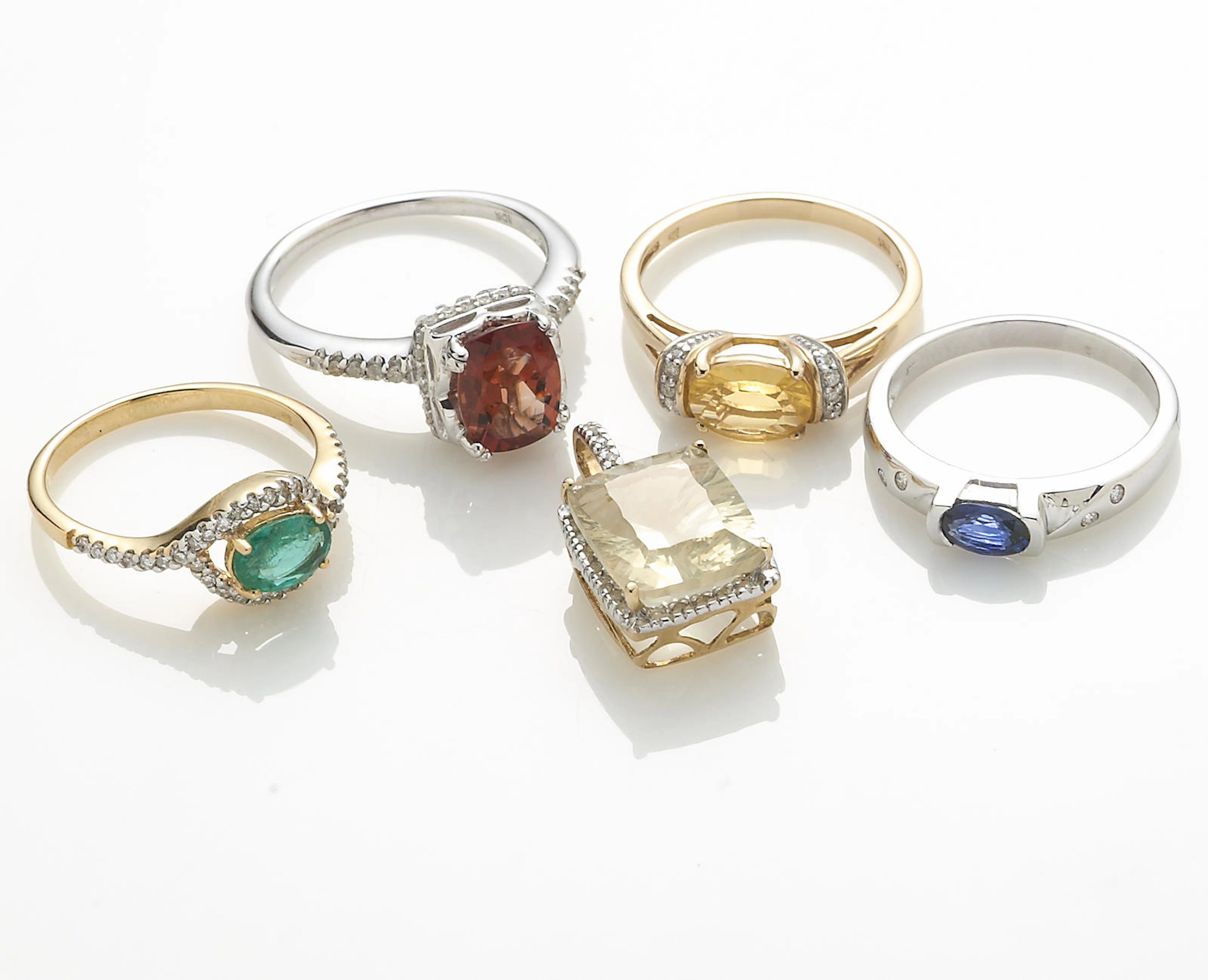 A collection of five gem-set, diamond, and various karat white and yellow gold jewelry items