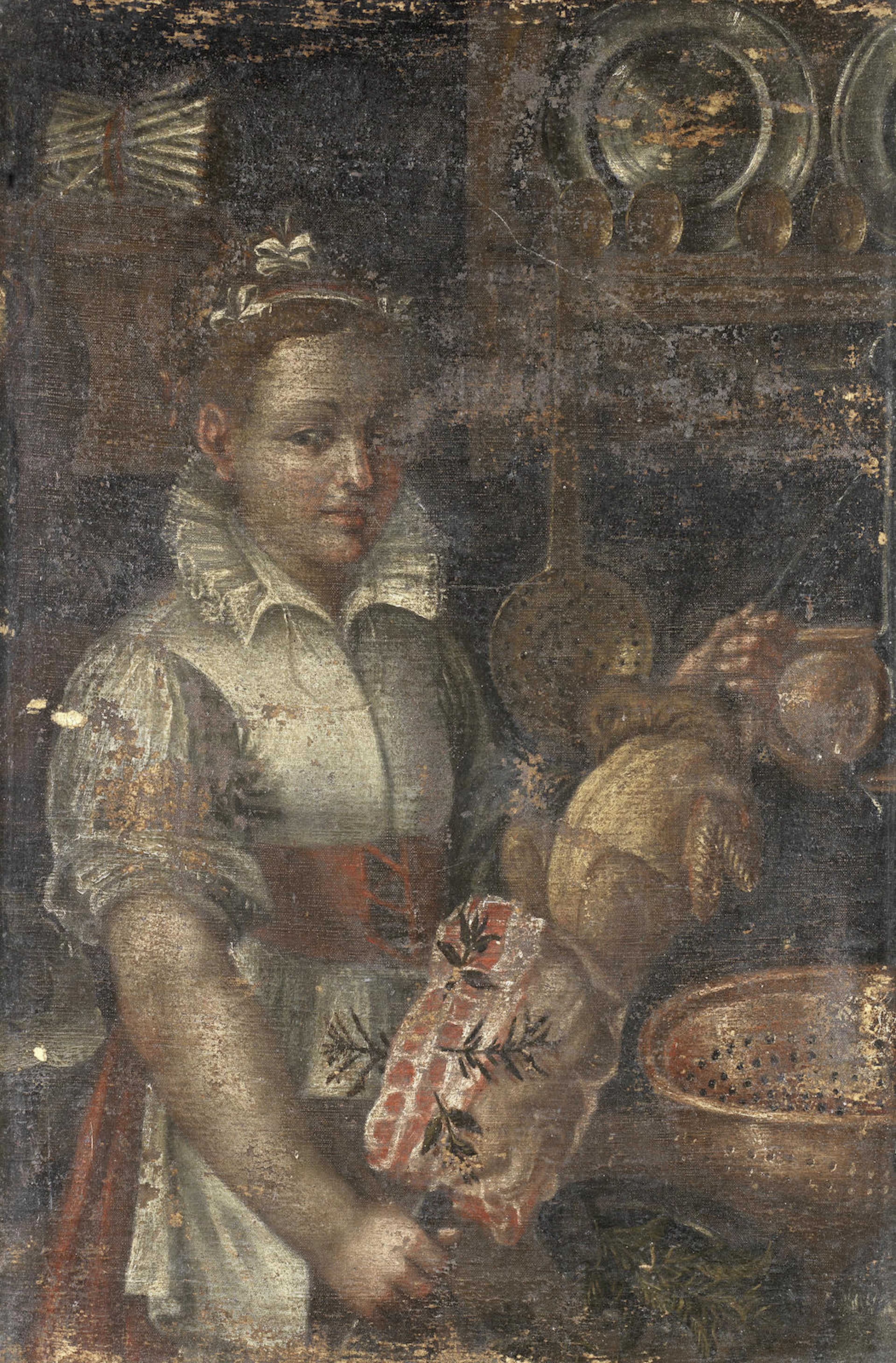 A young woman cooking meat in a kitchen interior