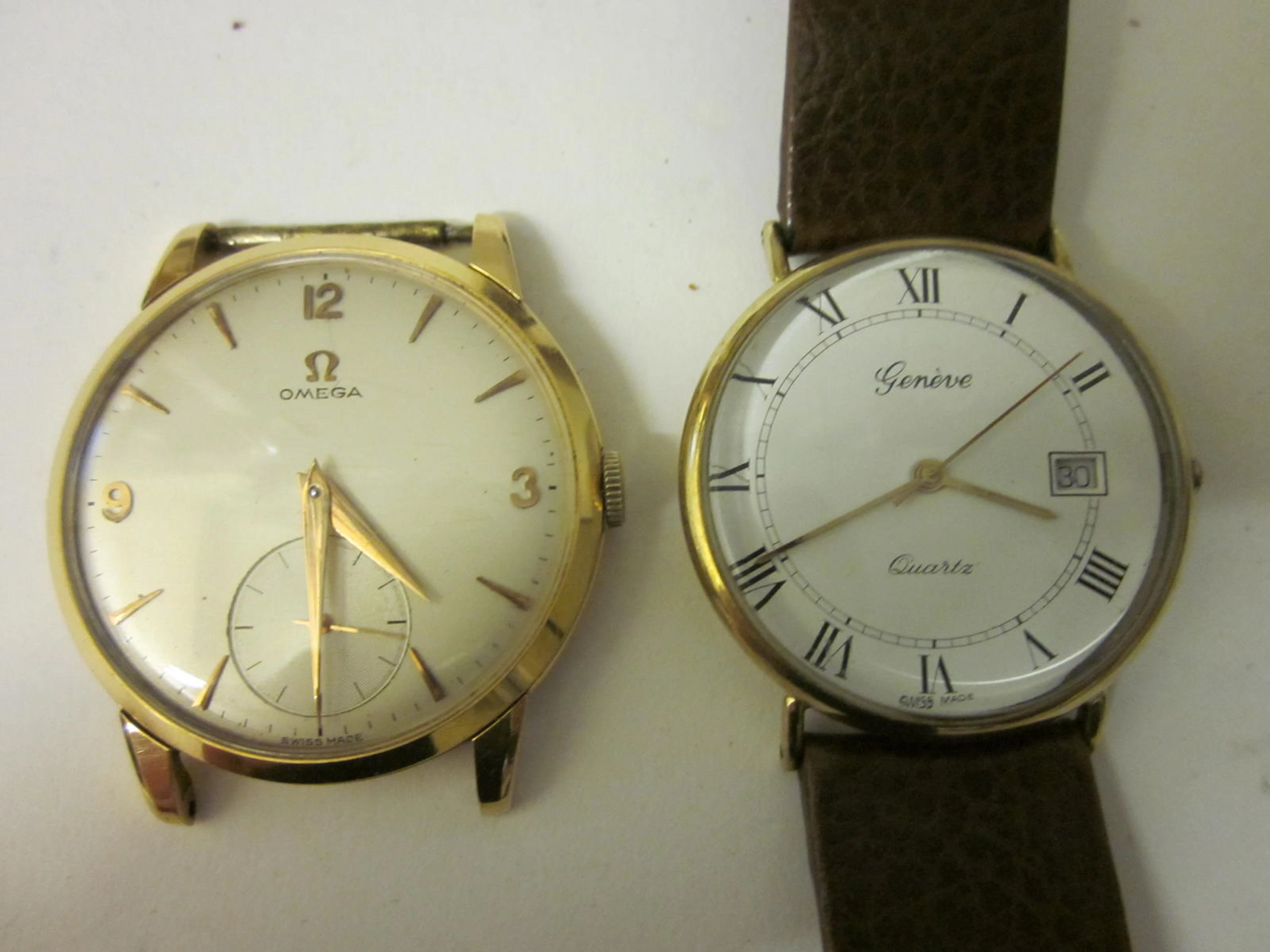 Omega: An 18 carat gold watch head, (2)