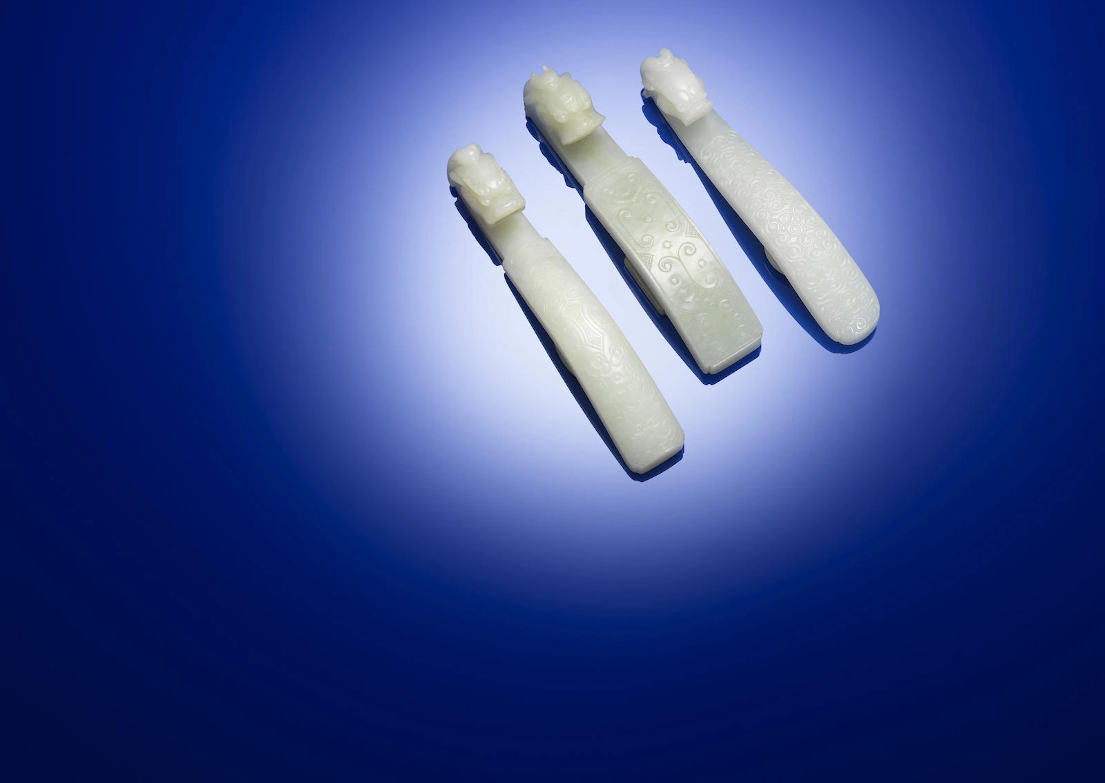 Three jade 'archaistic scroll' belt hooks Qing dynasty