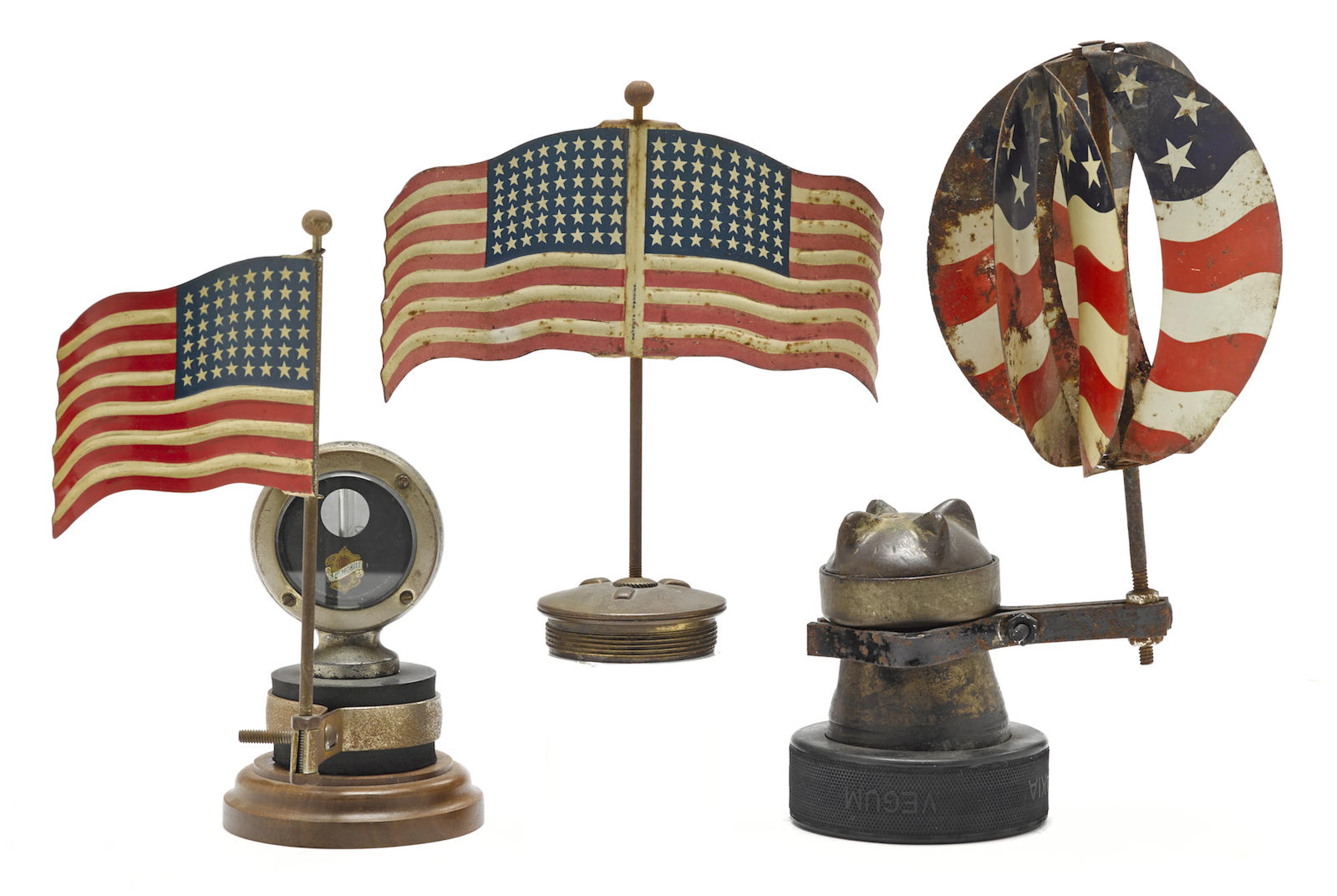 A lot of three Americana tin painted flag mascots and radiator embelishments,