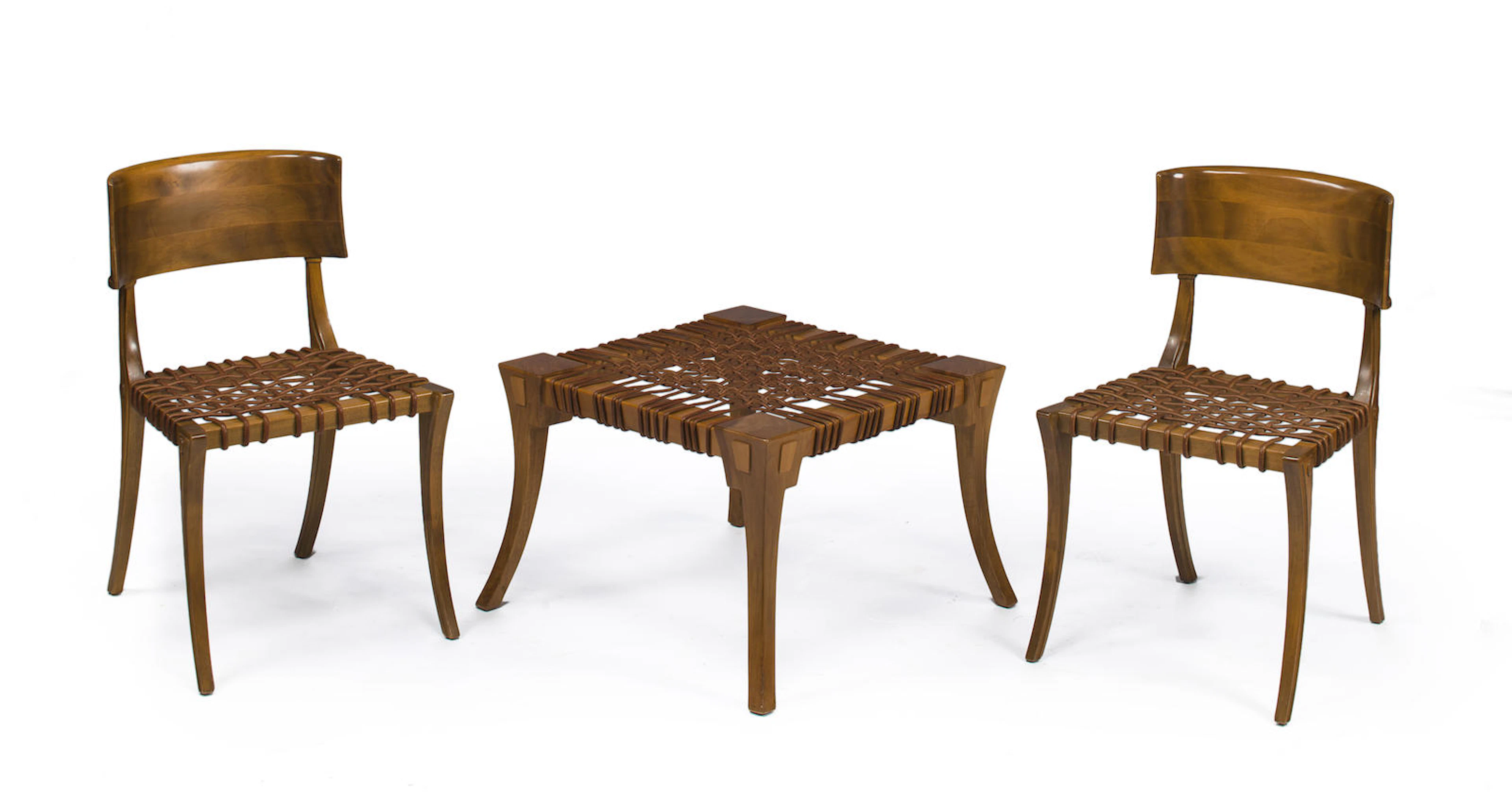 A pair of Robsjohn Gibbings for Saridis walnut and leather Klismos chairs and matching bench designed 1961