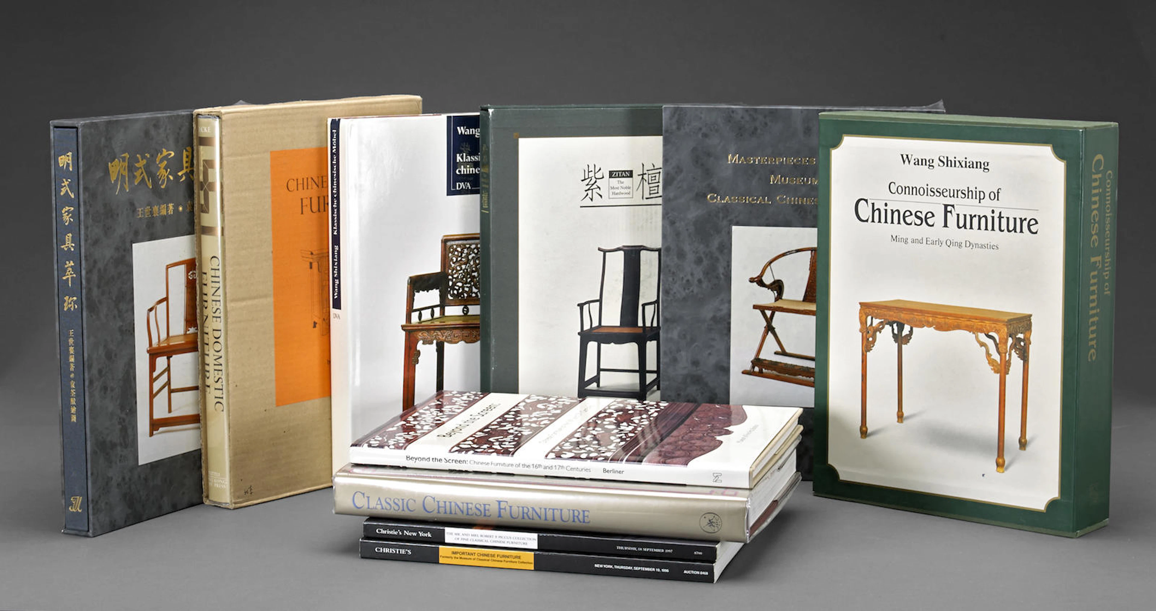 A group of eleven books and catalogs on Chinese furniture and a framed calligraphy by Wang Shixiang