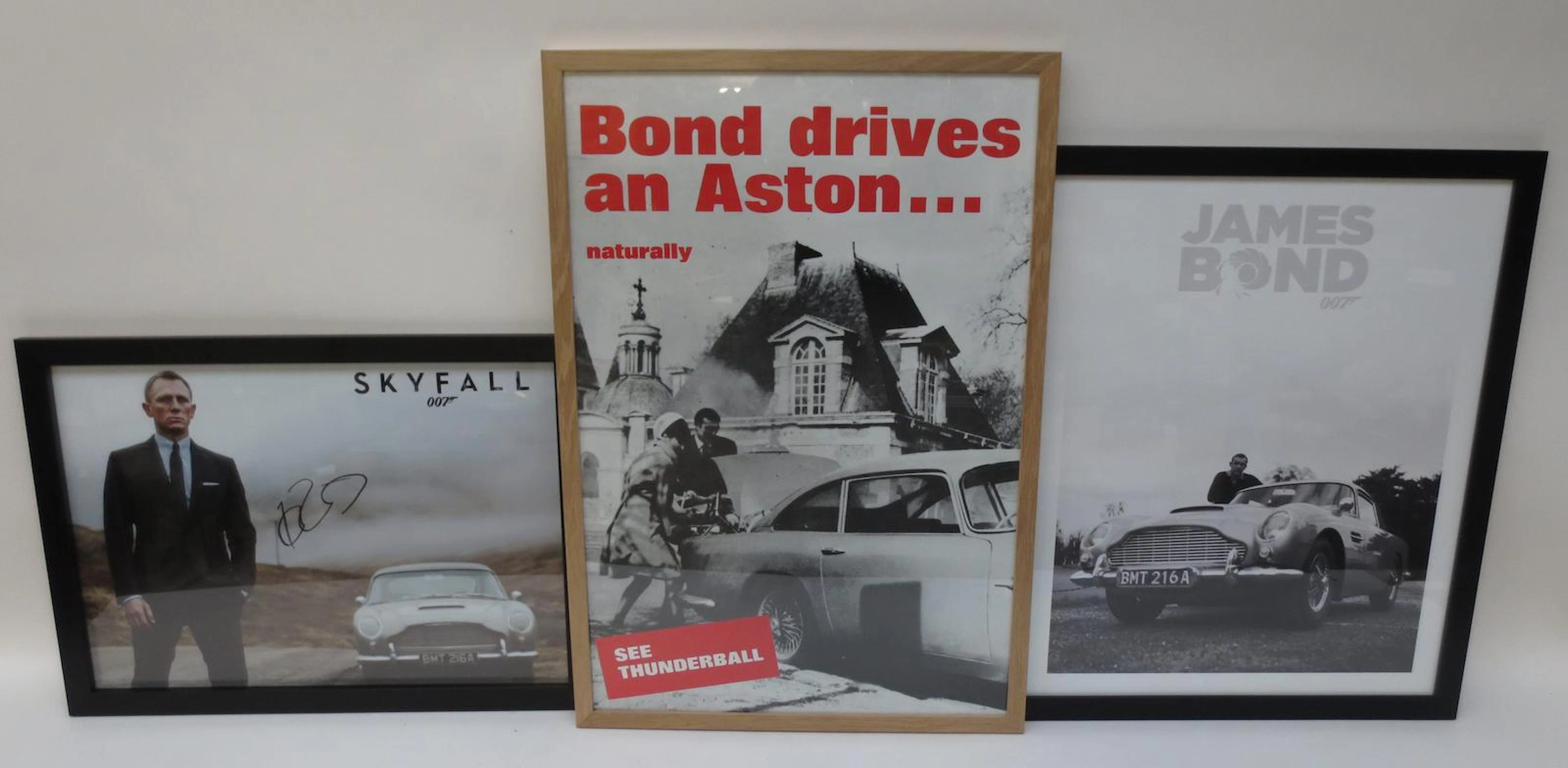 Three James Bond posters featuring the Aston Martin DB5,