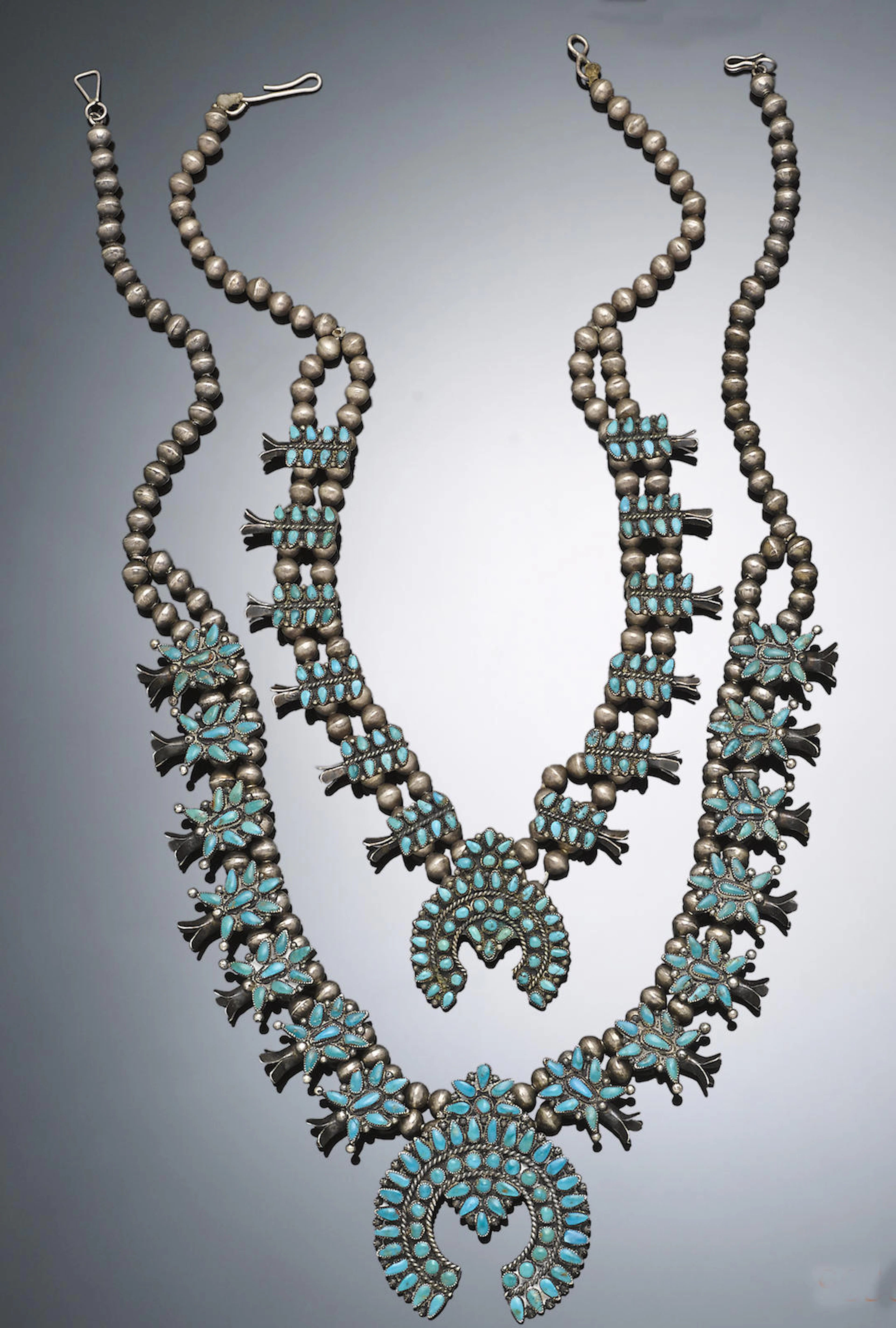 Two Zuni squash blossom necklaces