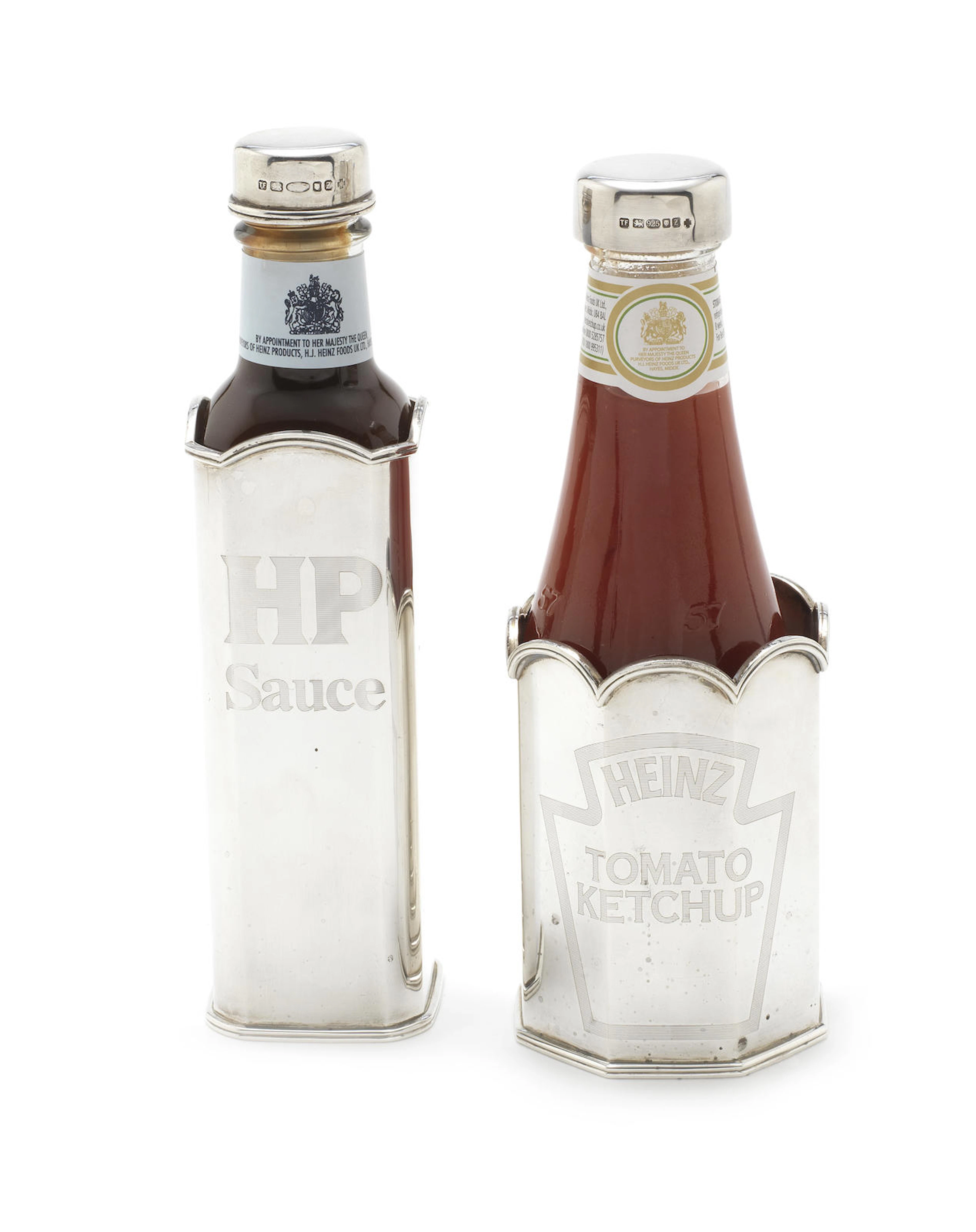 Two silver 'Heinz ketchup' and 'HP Sauce' bottle sleeves with caps by Theo Fennell, London 1999 (2)