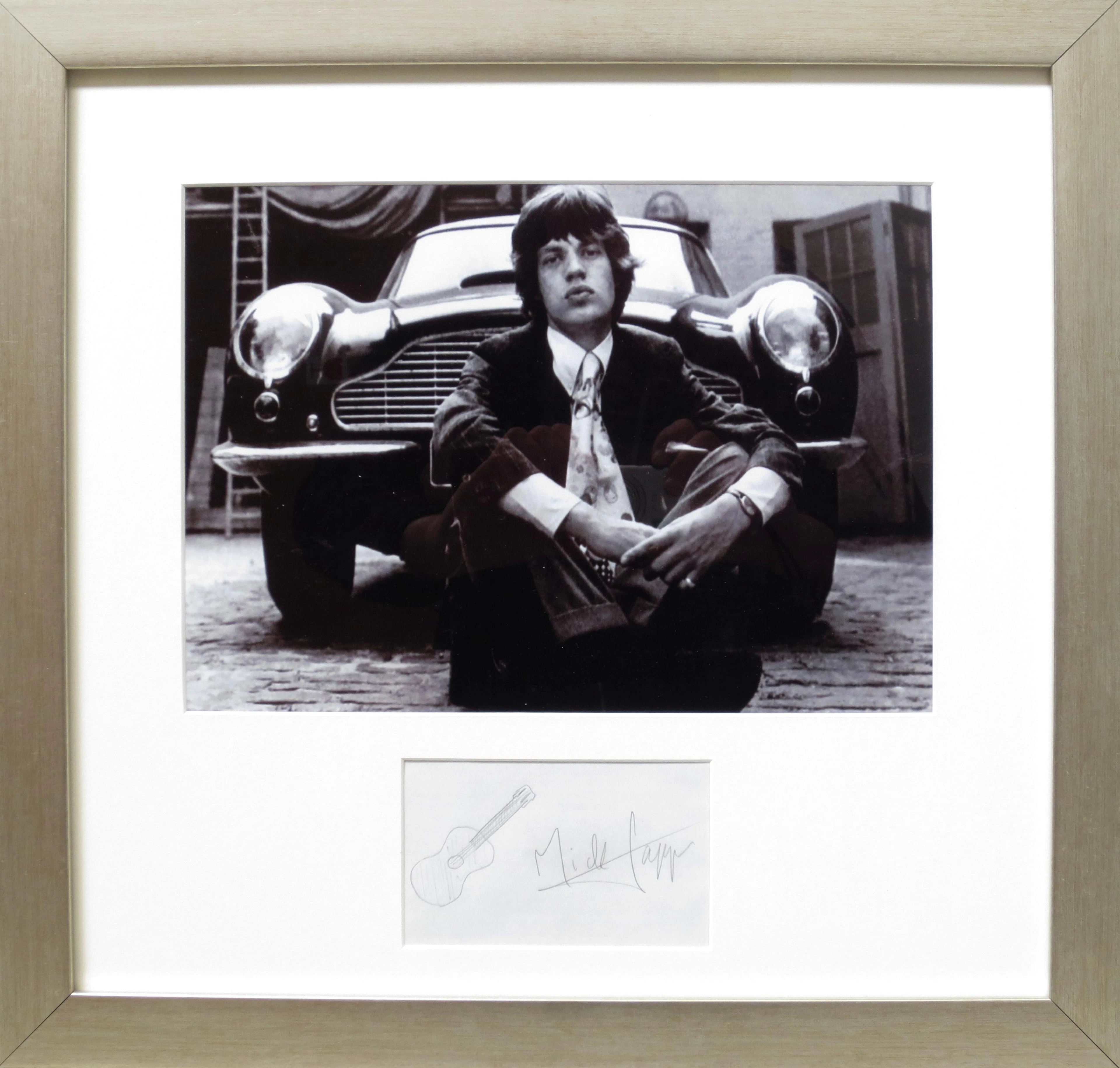 A framed photograph with signature of Mick Jagger and his Aston Martin DB6,