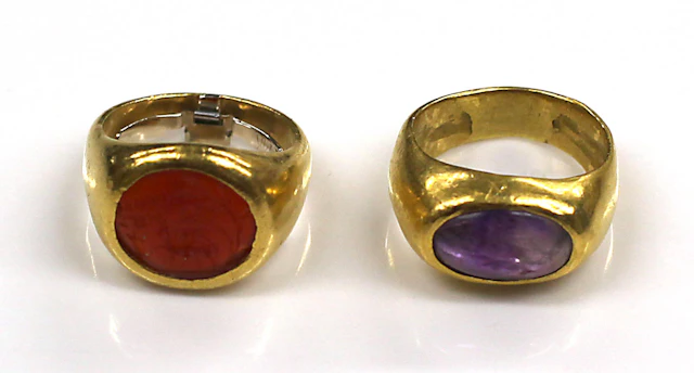 Two amethyst, carnelian intaglio and high karat gold rings