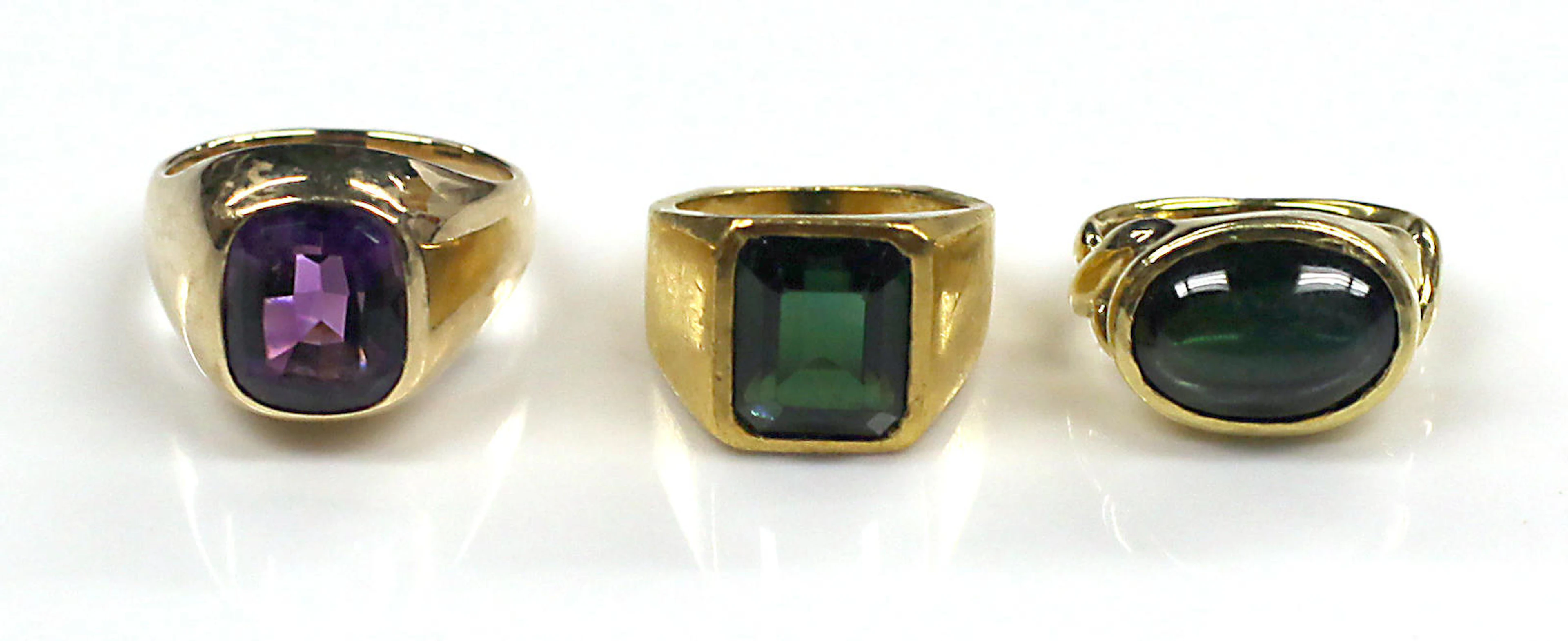 Two green tourmaline, high karat and 18k gold rings, together with an amethyst and 14k gold ring
