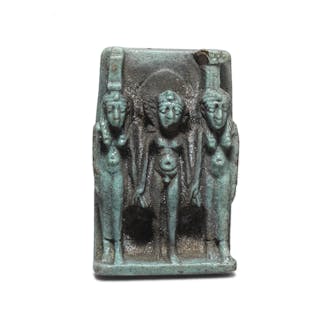 An Egyptian pale green glazed faience triad amuletic plaque