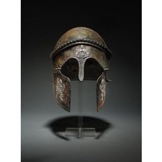 An important Etruscan bronze Chalcidian-type helmet, with silver appliqués