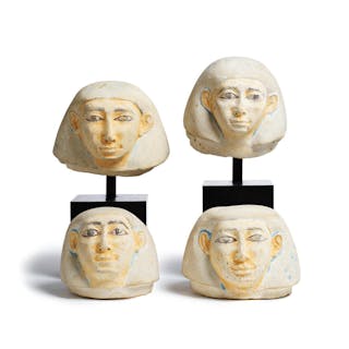 Four Egyptian limestone human-headed canopic jar lids