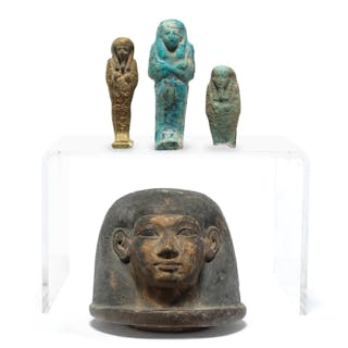 An Egyptian human-headed pottery canopic jar lid and three Egyptian