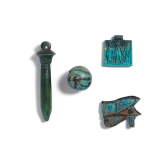 Three Egyptian glazed faience amulets and an Egyptian faience bichrome