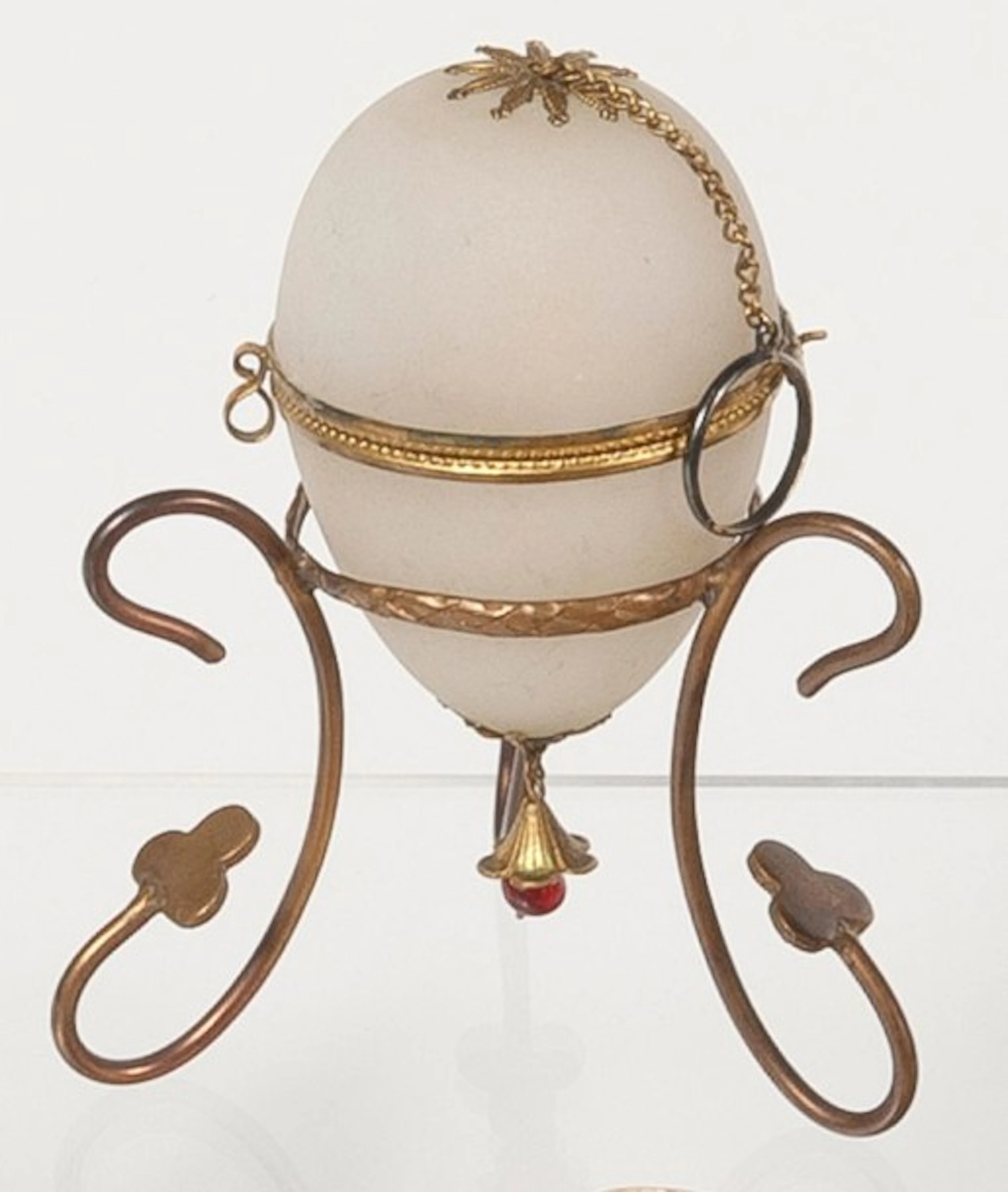 White opaline sewing box in the shape of an egg on golden metal armature
