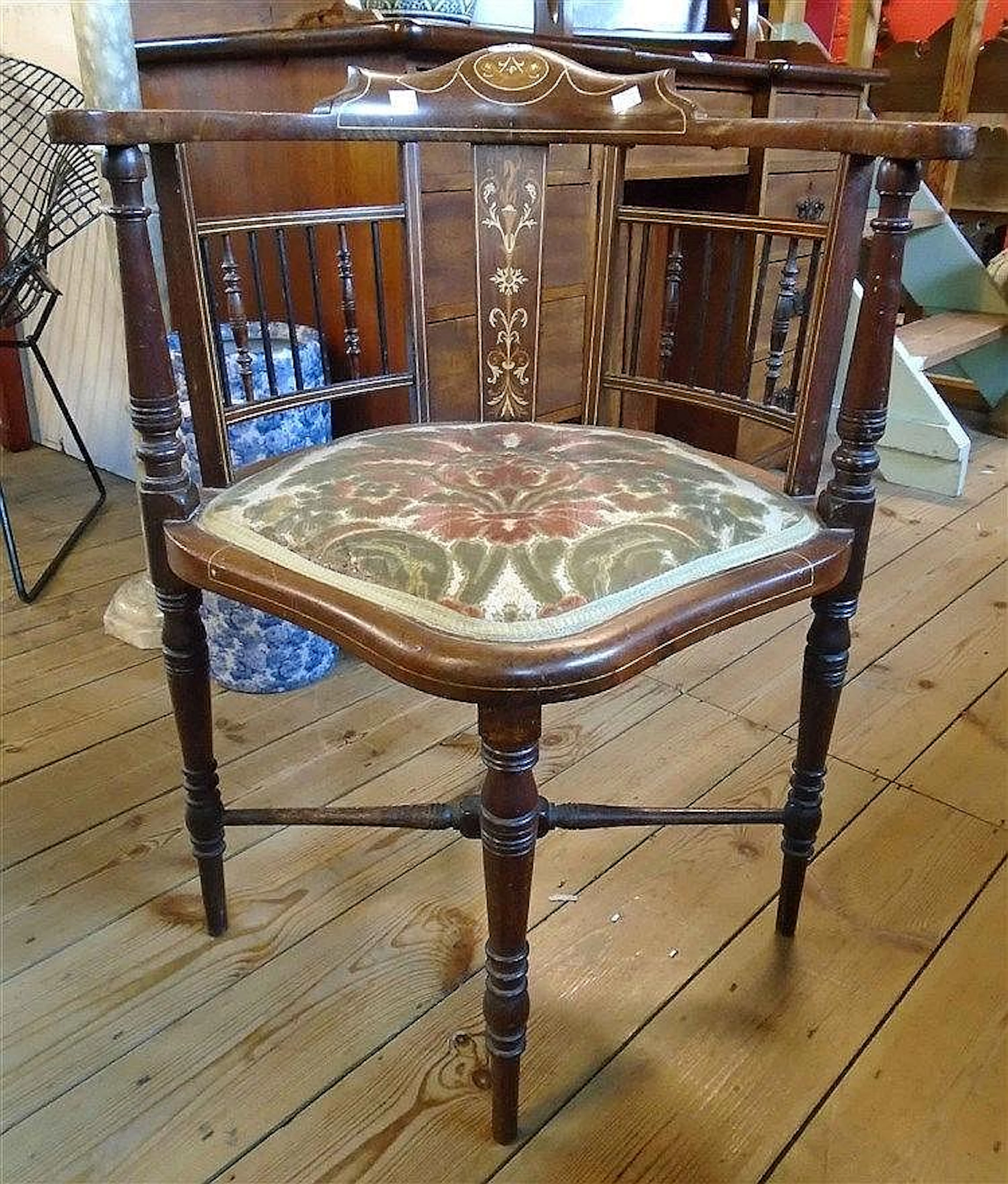 An Edwardian inlaid walnut corner elbow chair with decorative splat, slende