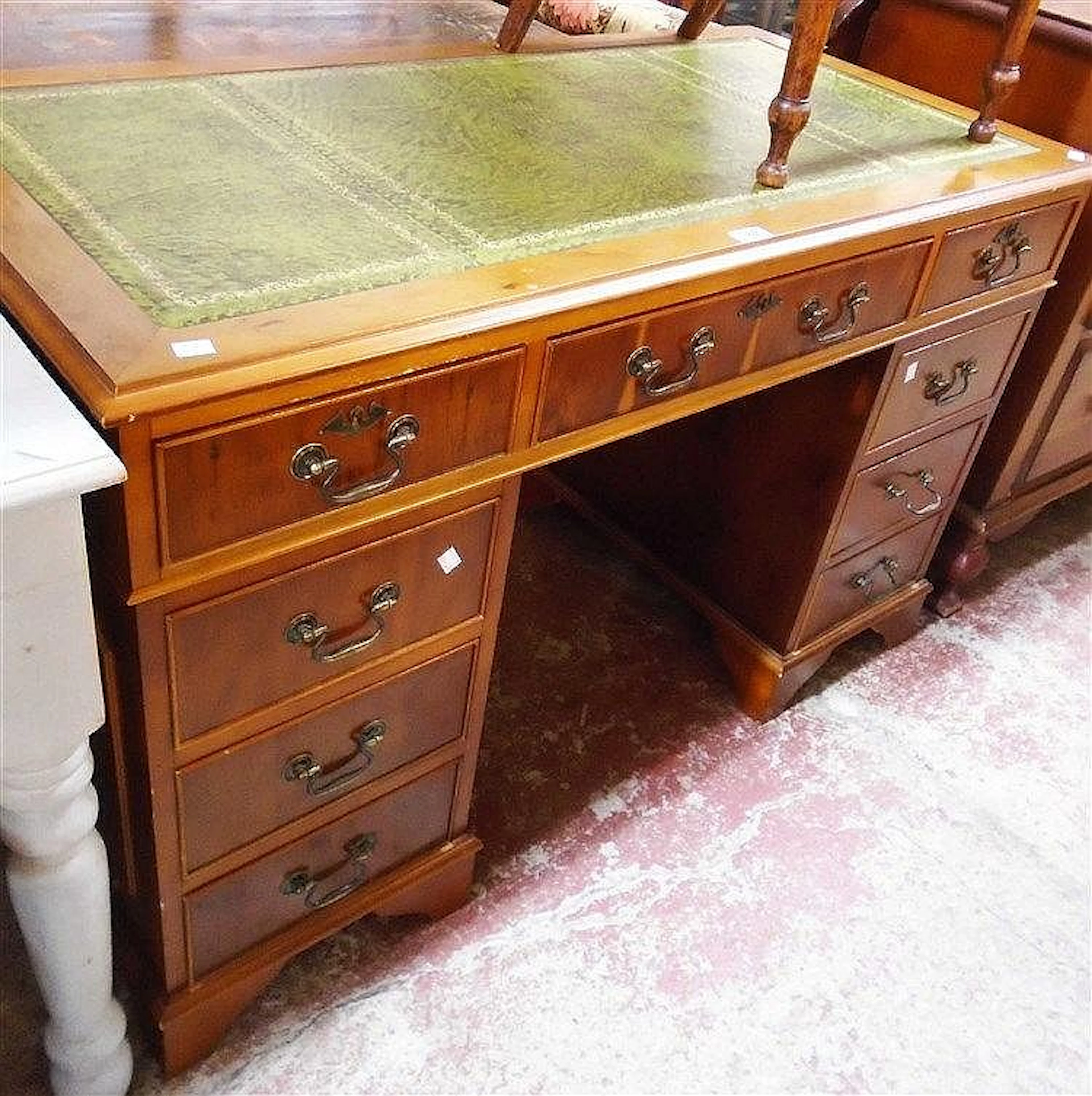 A 4' reproduction yew twin pedestal desk with green leather inset top, thre