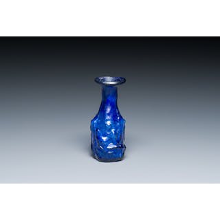 A Roman ‘Sidonian’ dark blue 'erotic subject' molded glass bottle
