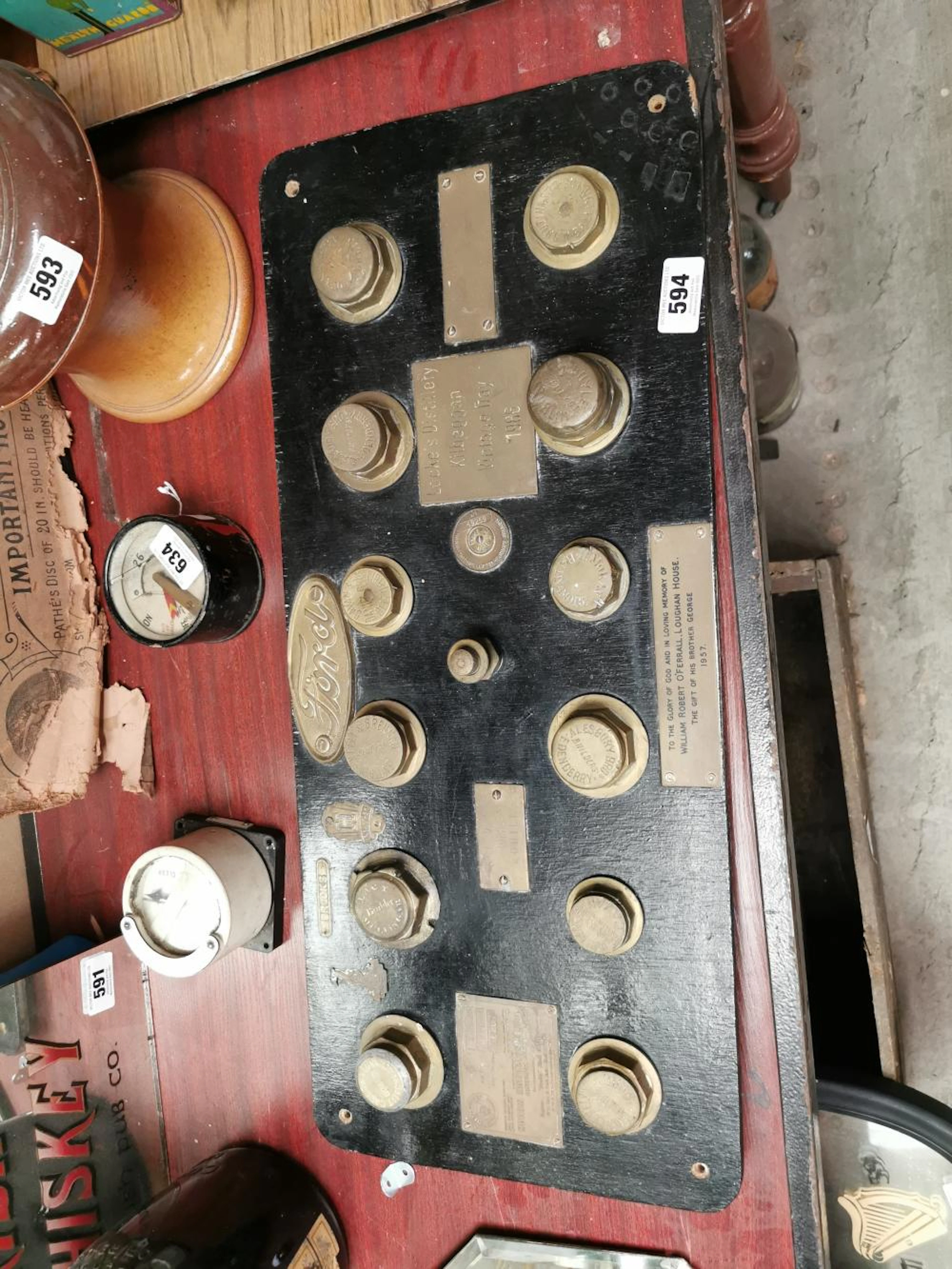 Car memorabilia mounted on a wooden board