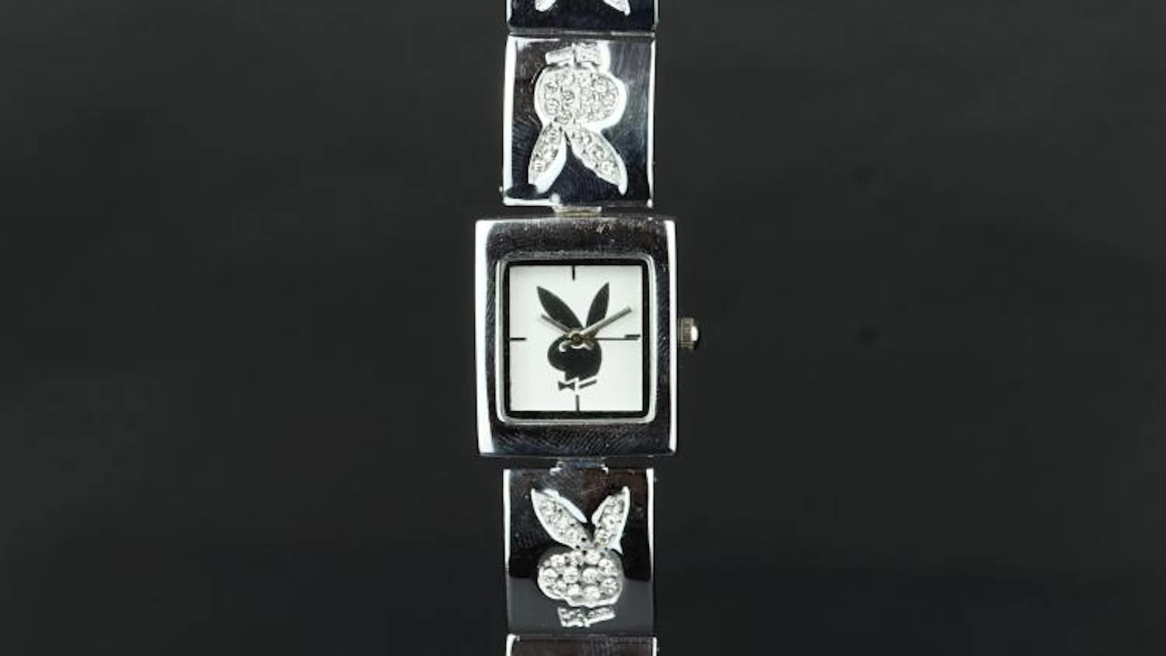 LADIES' QUARTZ WATCH playboy motif on square dial 20x25mm.