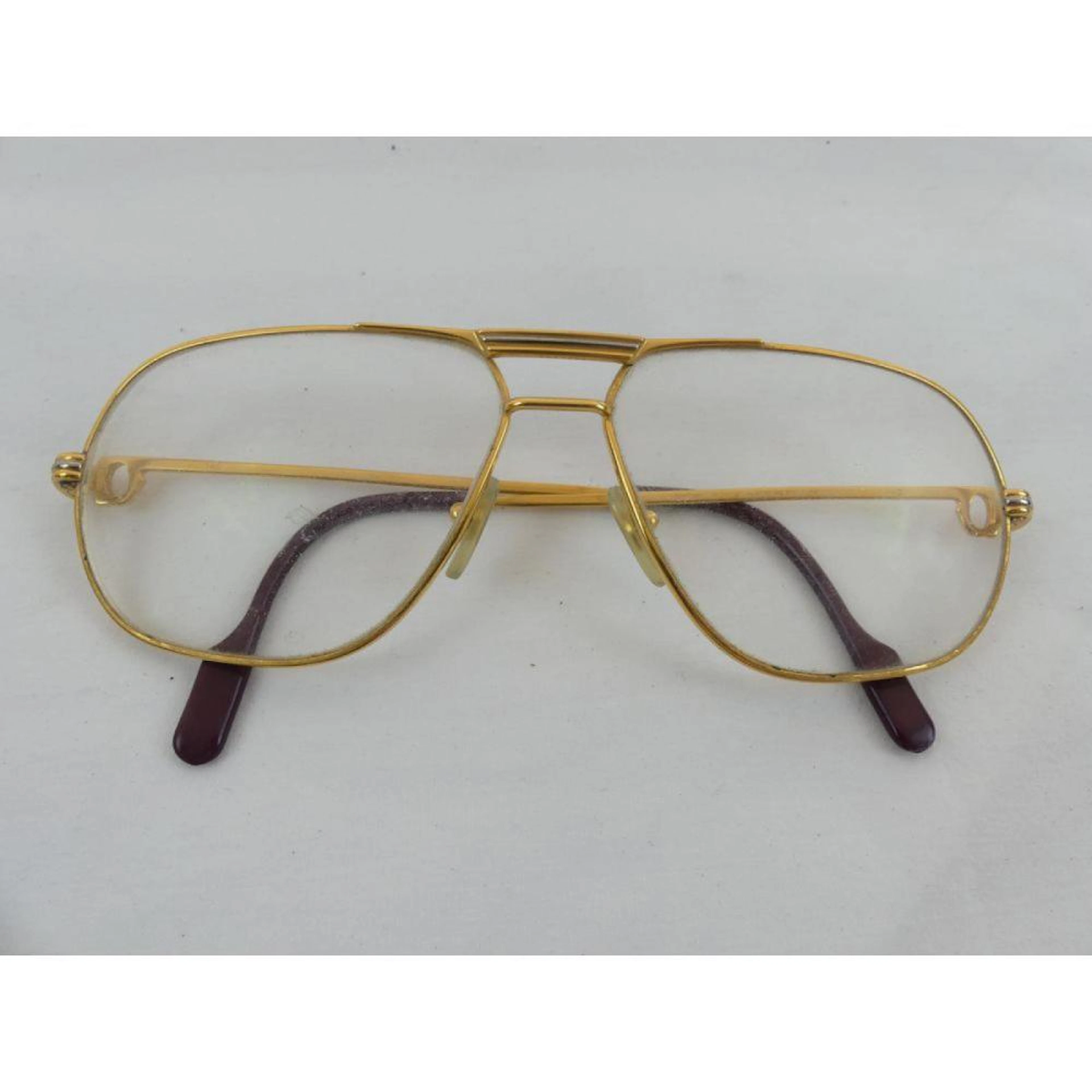 CARTIER. Lunettes de vue en métal doré. Signées et numérotées. Dans leur boîte.