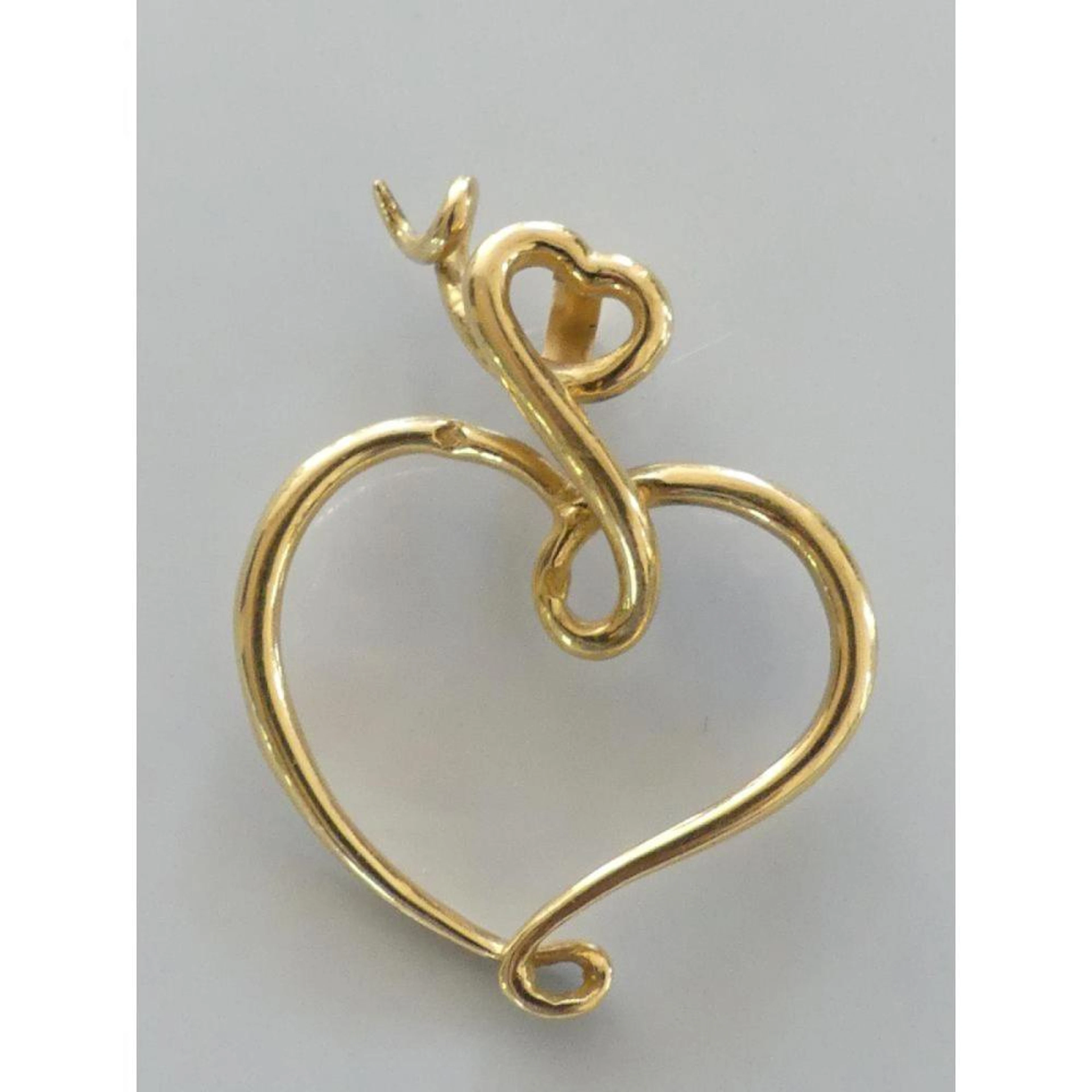 PENDENTIF en or 750°/°° représentant un c?ur évidé. 4x3cm. PB.8,89grs.