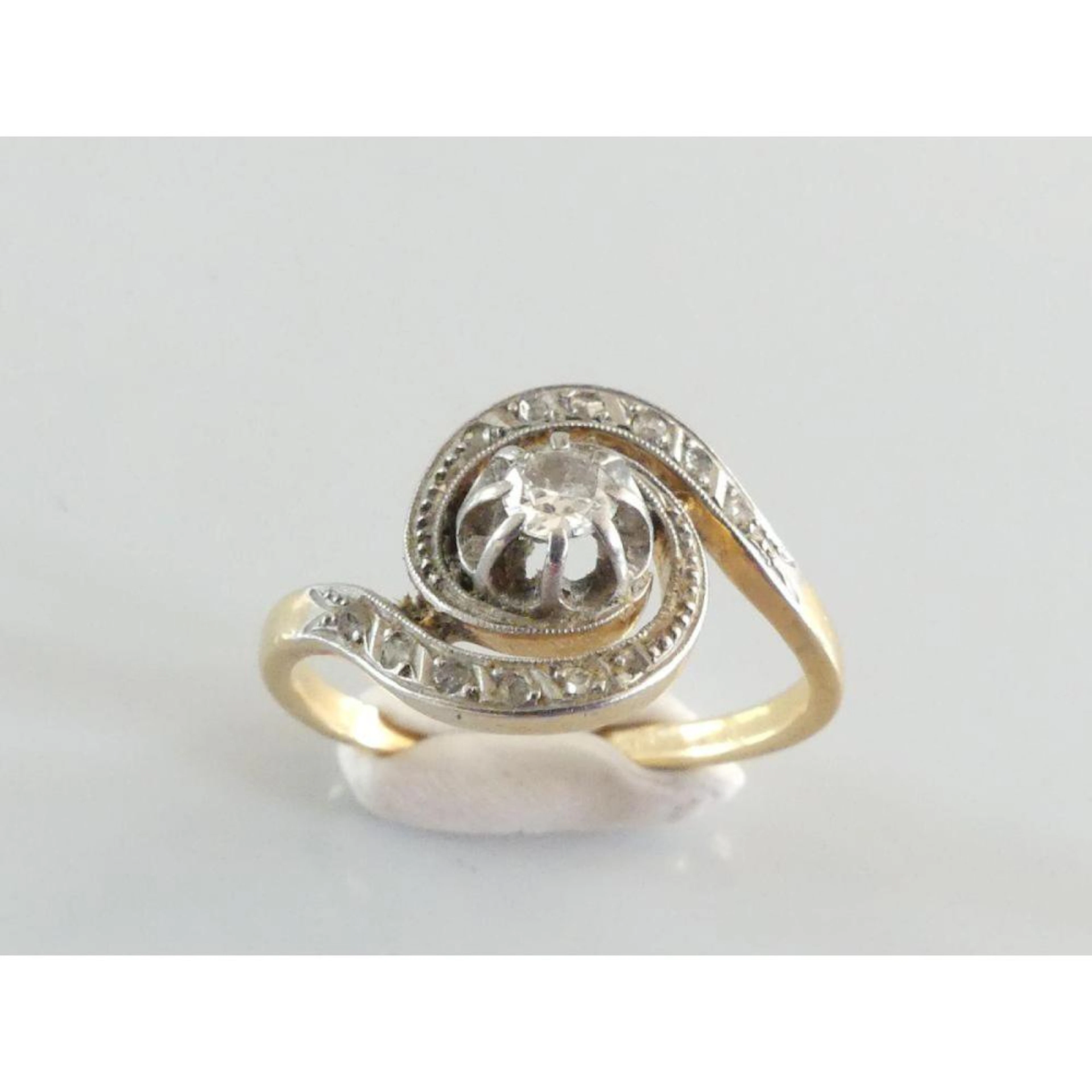 BAGUE tourbillon 2 ors 750°/°° ornée d?un diamant taille...