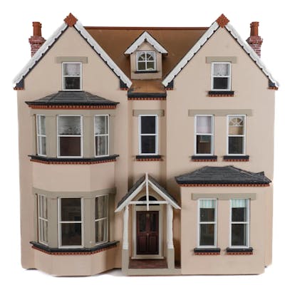 A PAINTED THREE STOREY DOLLS HOUSE