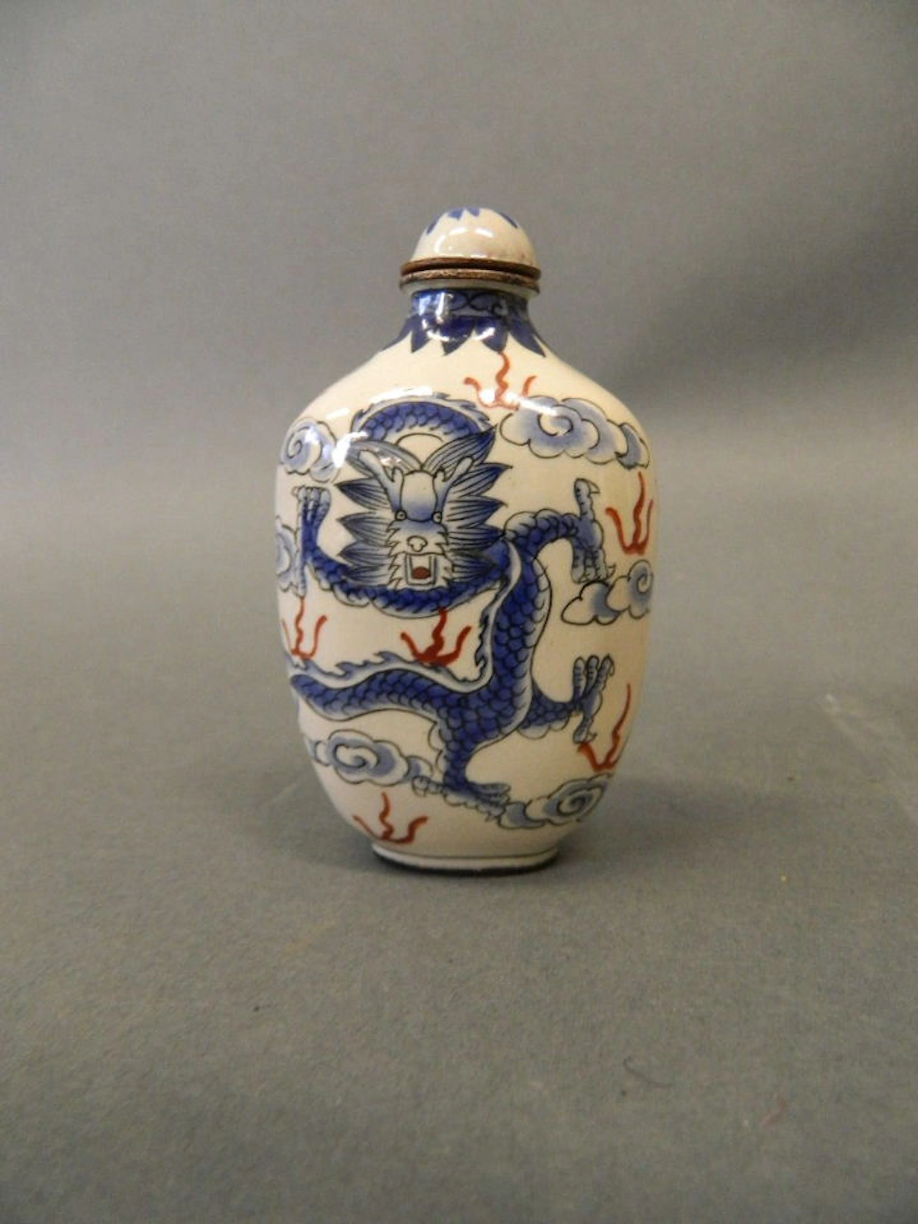 A Cantonese enamelled copper snuff bottle with dragon decoration