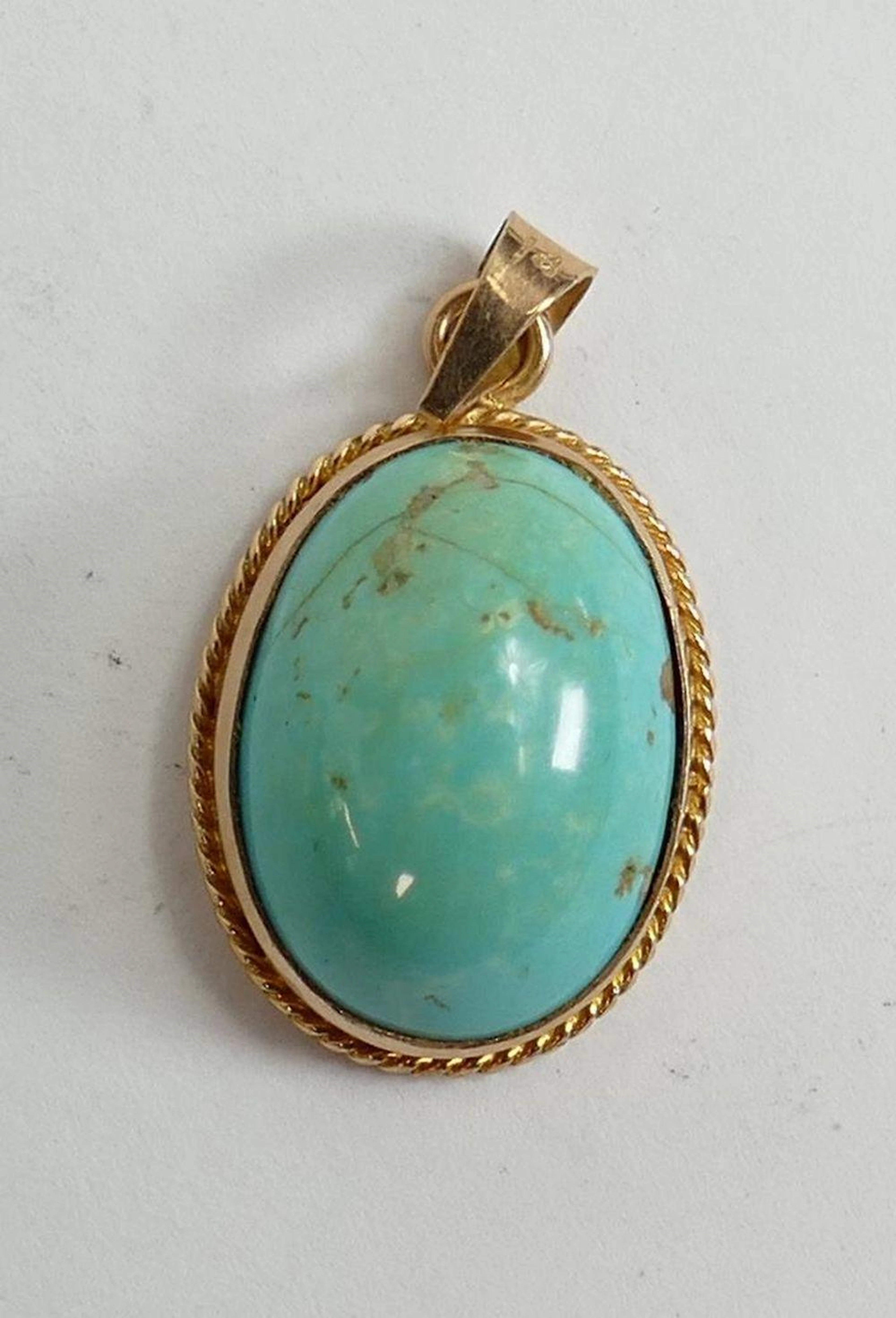 Turkish Yellow metal oval pendant set with turquoise agate stone.