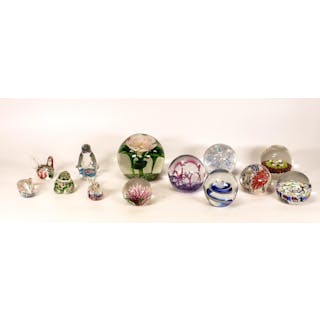 A collection of glass paperweights to include Murano