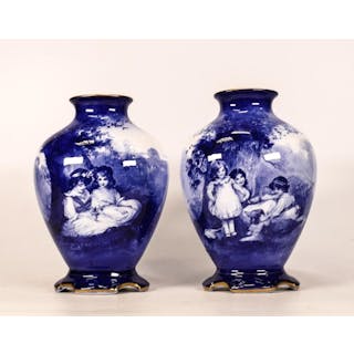 A pair of Royal Doulton blue & white vases with scenes of children .