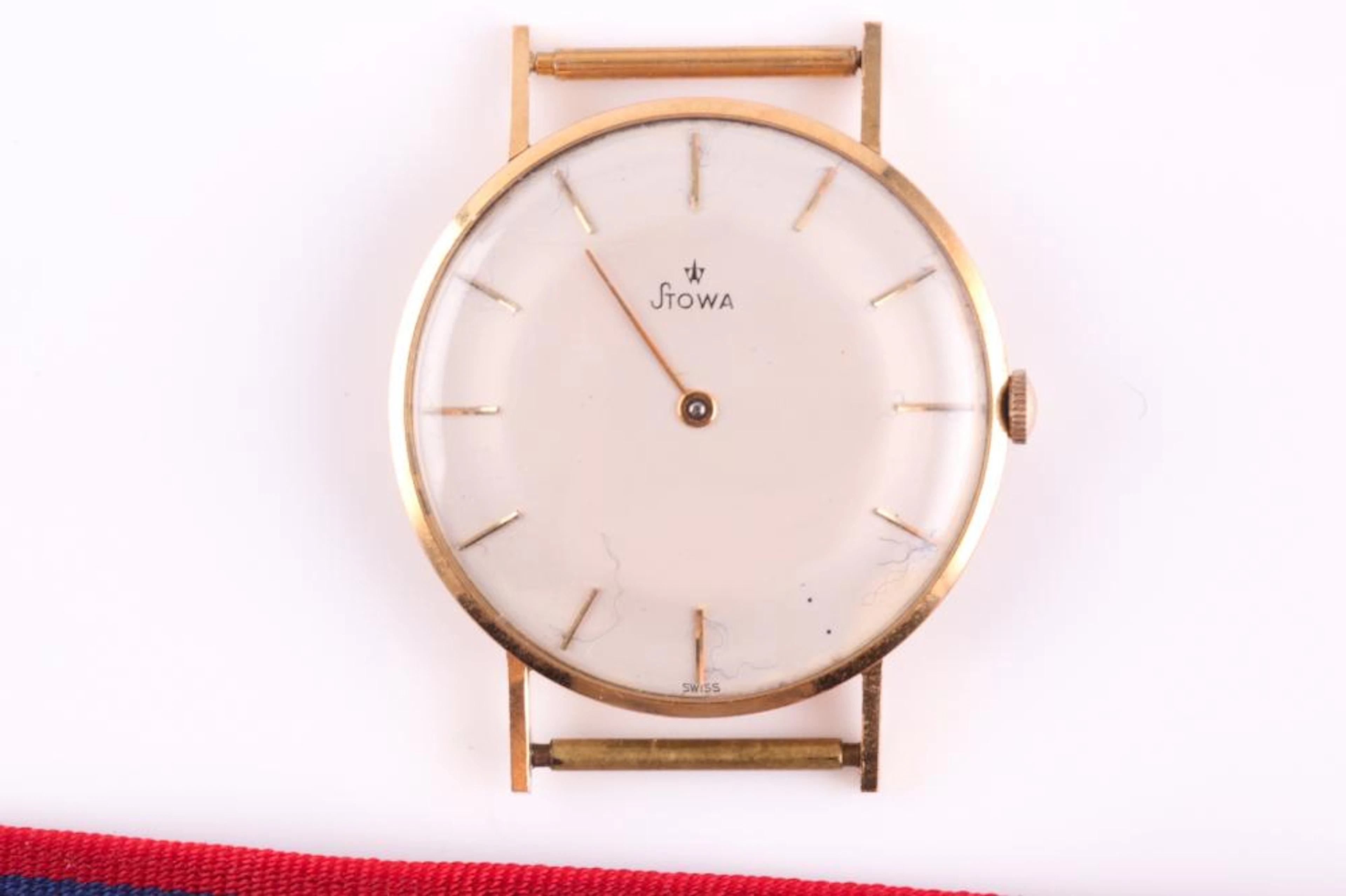 A yellow metal Stowa watch, the plain cream dial wi