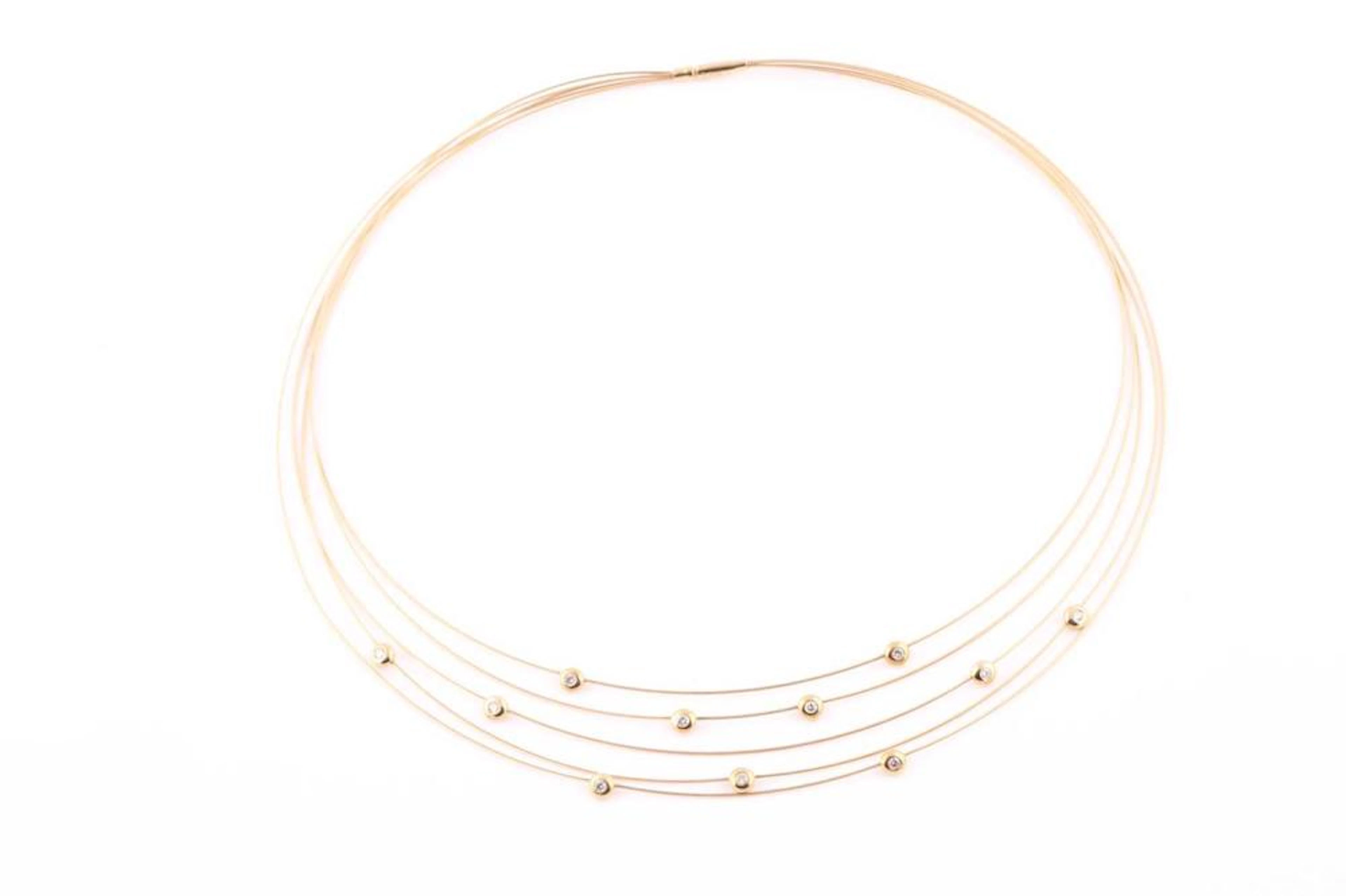 A yellow metal collar necklace the five strands set with...