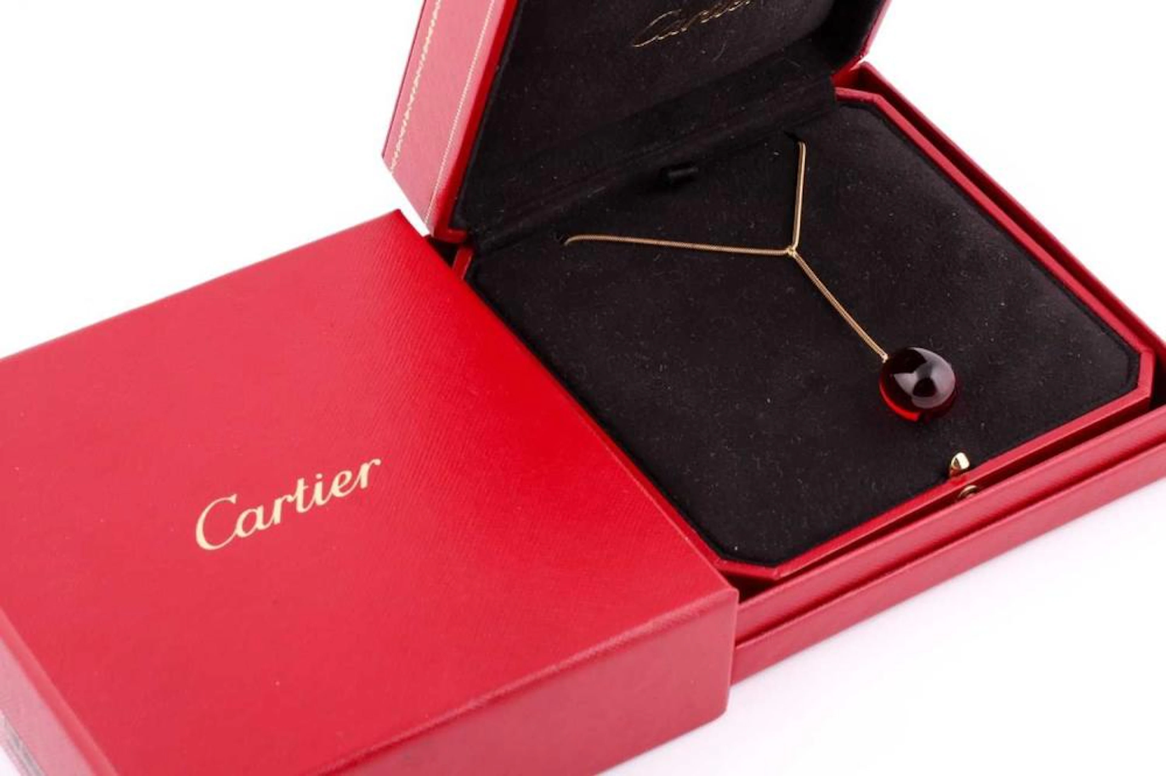 A Baccarat red crystal egg pendant necklace, on 18ct yellow gold snake link
