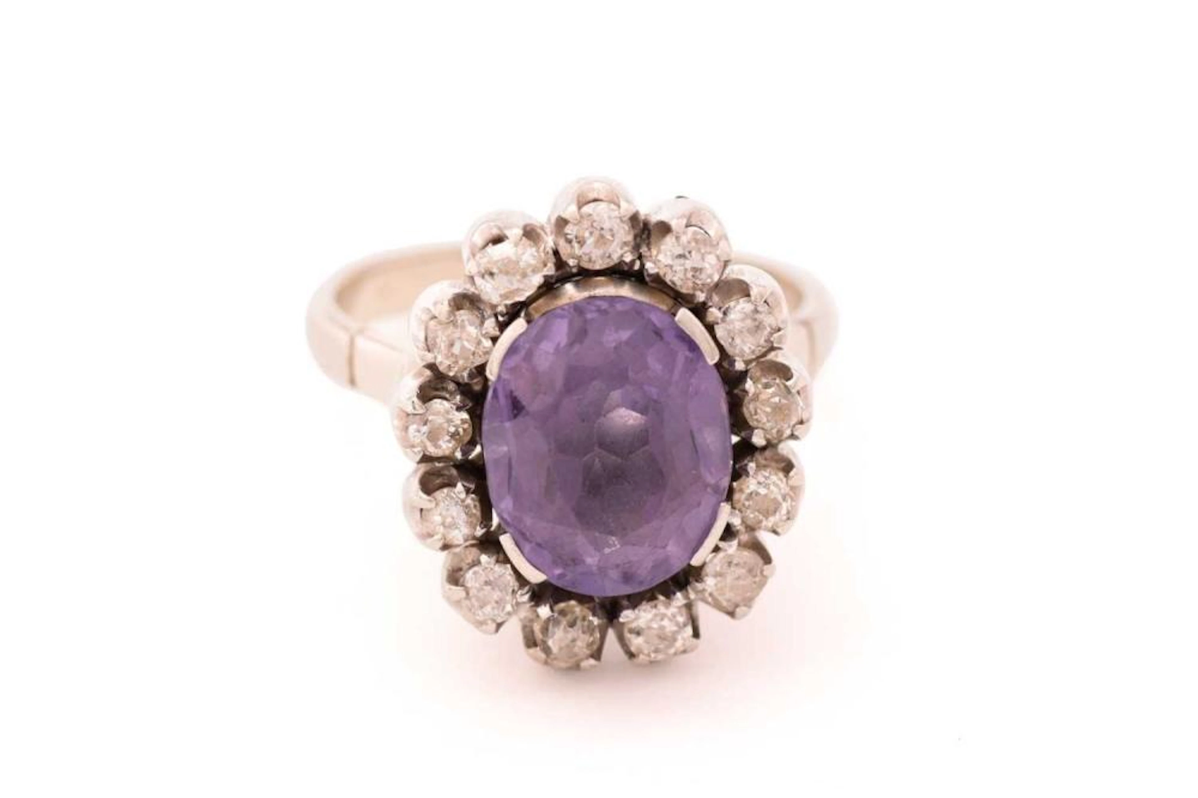 A synthetic colour-changing sapphire and diamond cluster ring