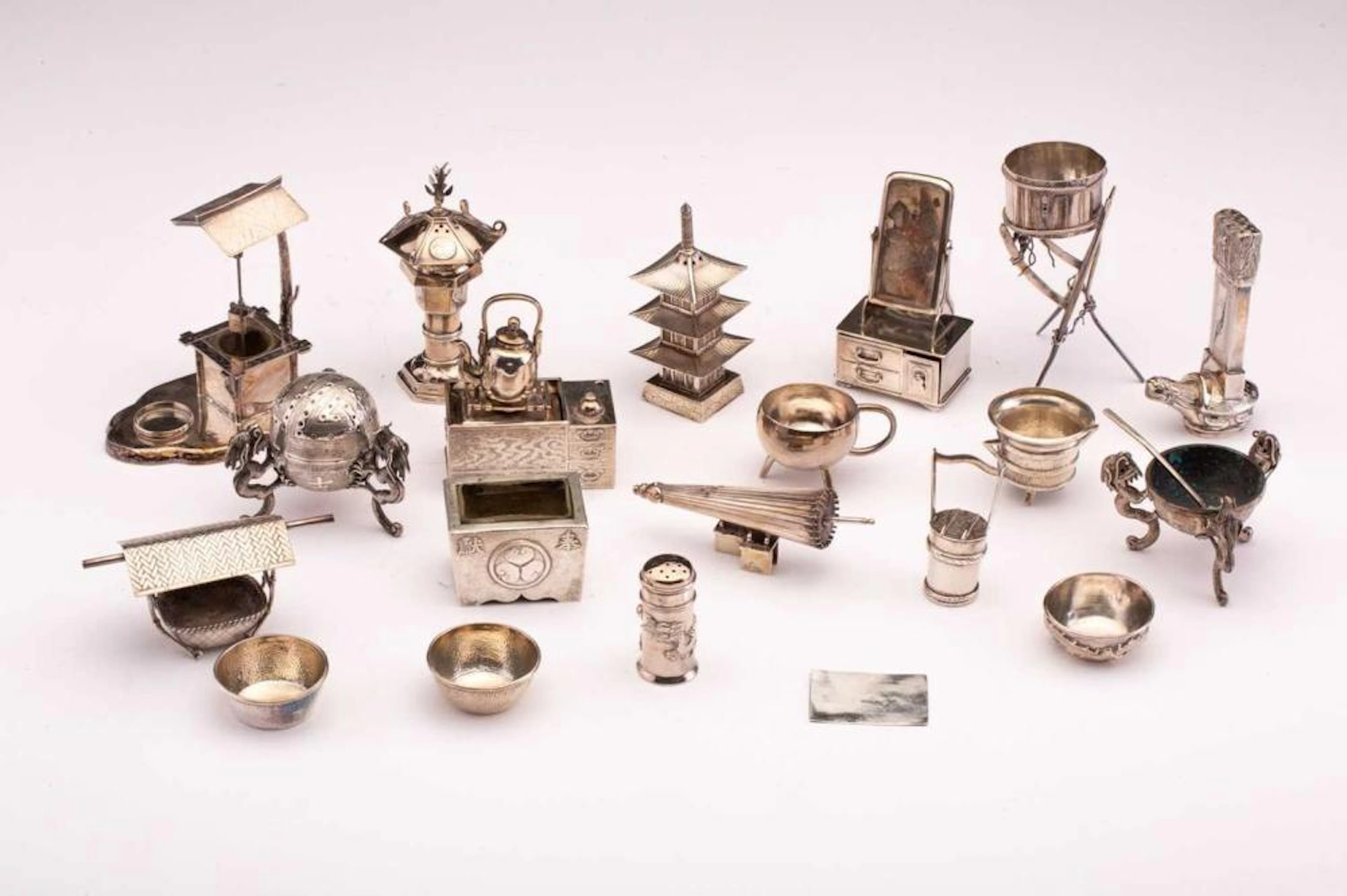 A collection of Oriental miniature white metal items