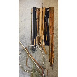 A collection of antique fly fishing rods with bags & fishing...
