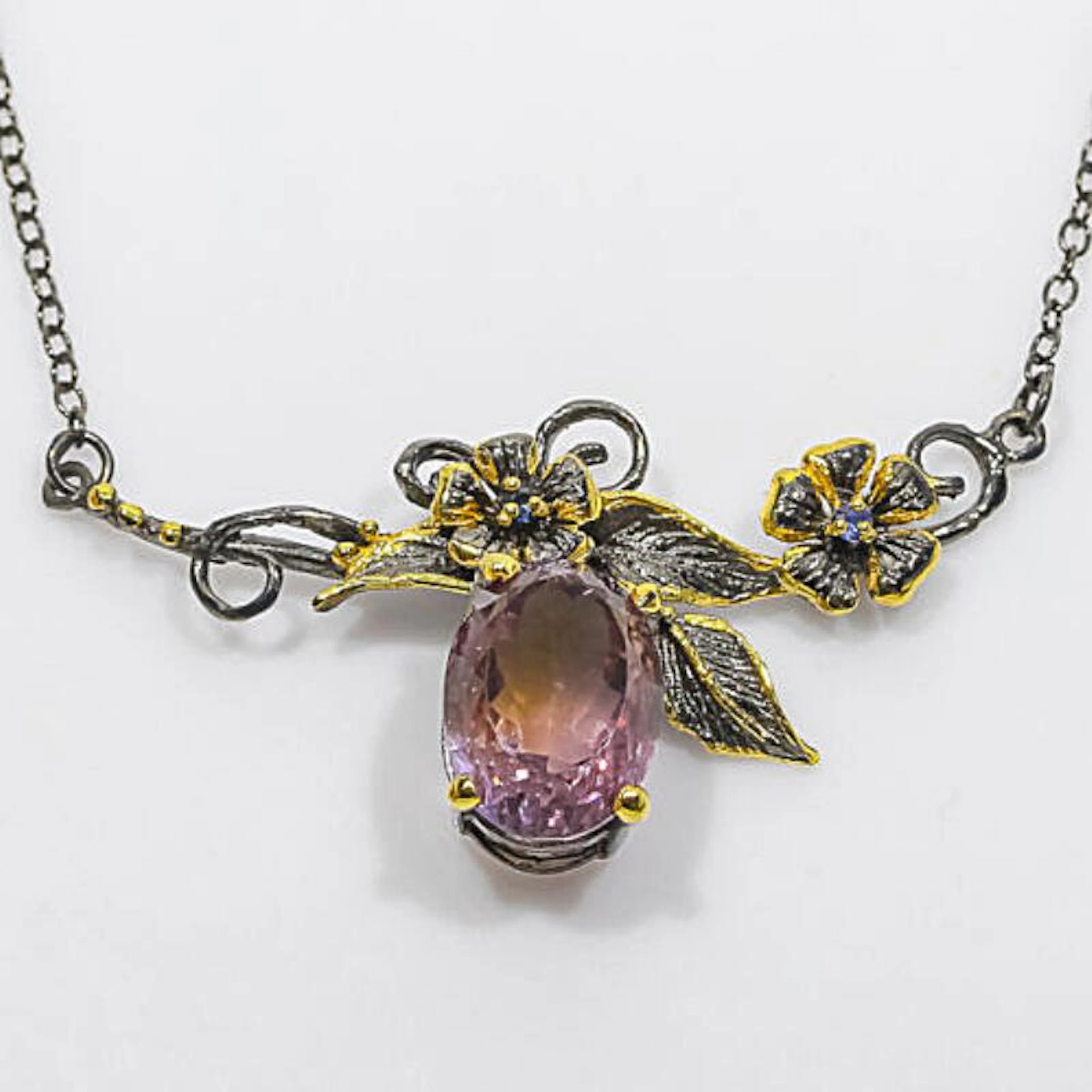 An ametrine necklace set with an oval-cut ametrine weighing app.