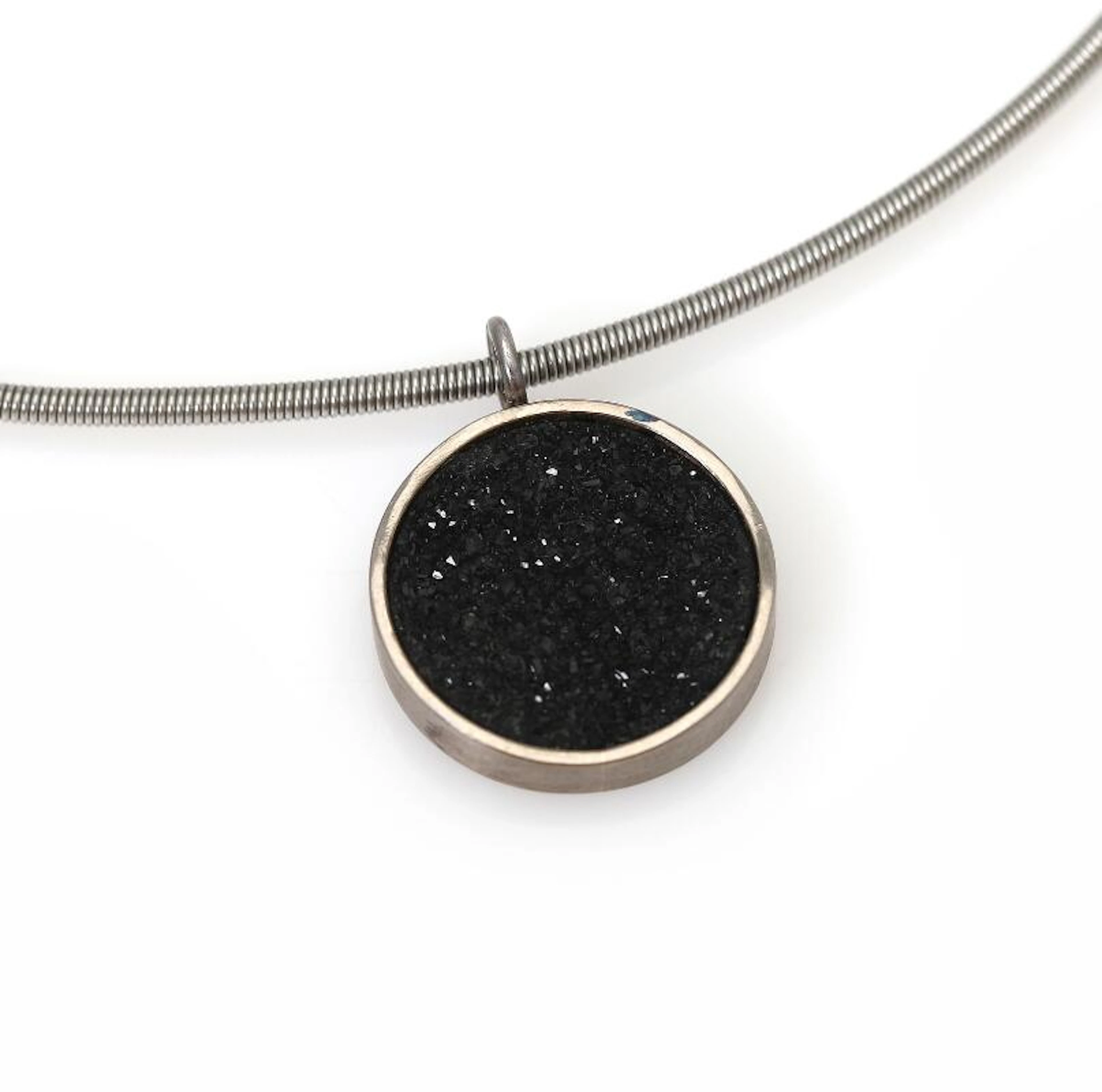 A quartz necklace with a pendant set with black drusy quartz